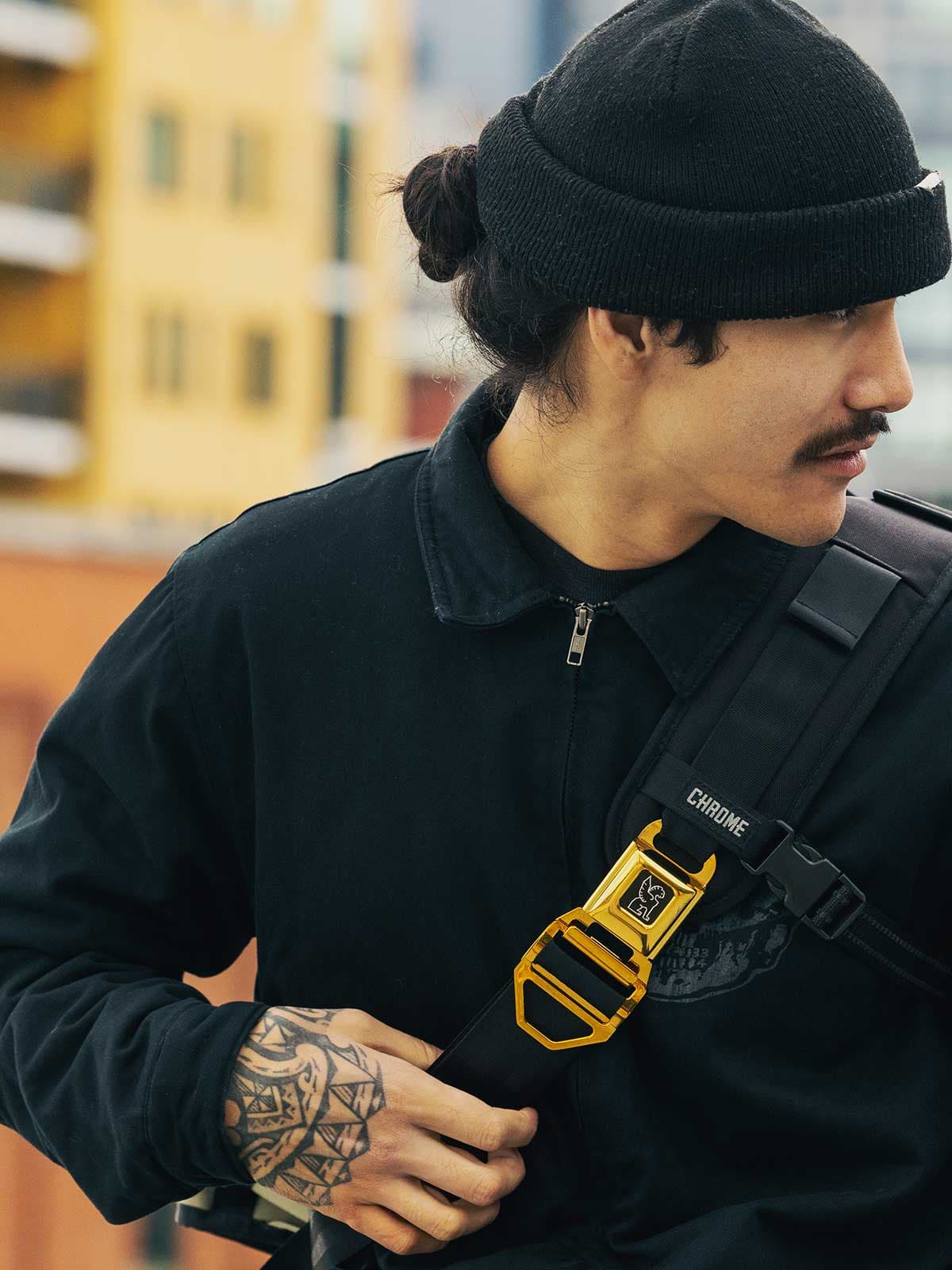 The Citizen Messenger with a gold buckle on a man wearing a black jacket