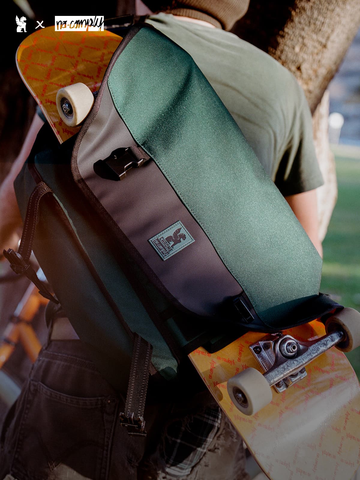 Person holding the Chrome X No-Comply Skate Messenger with a skateboard attached