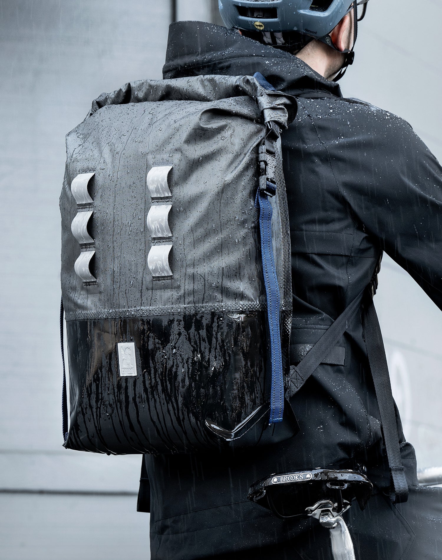 Waterproof Urban Ex bag on a guy riding a bike in the rain mobile size image