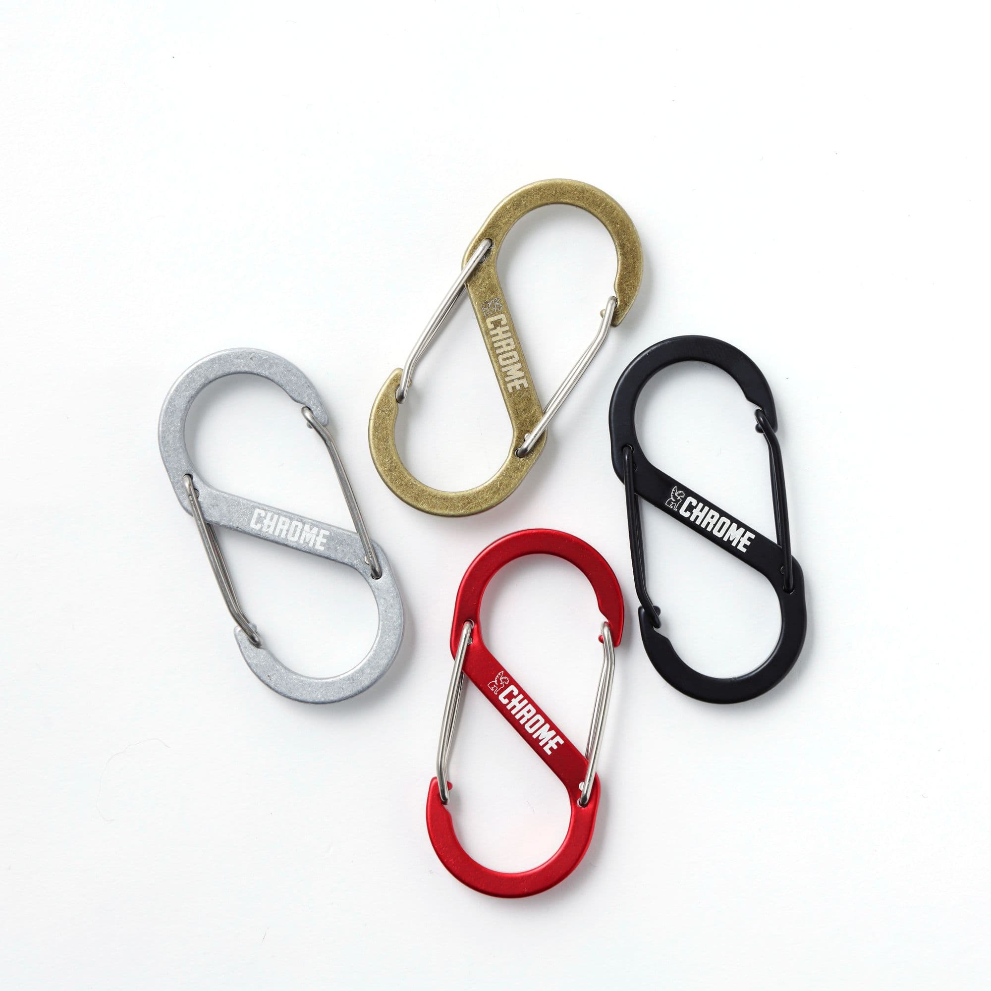 Four Chrome Industries Gear Clips in silver, gold, red, and black on a white background