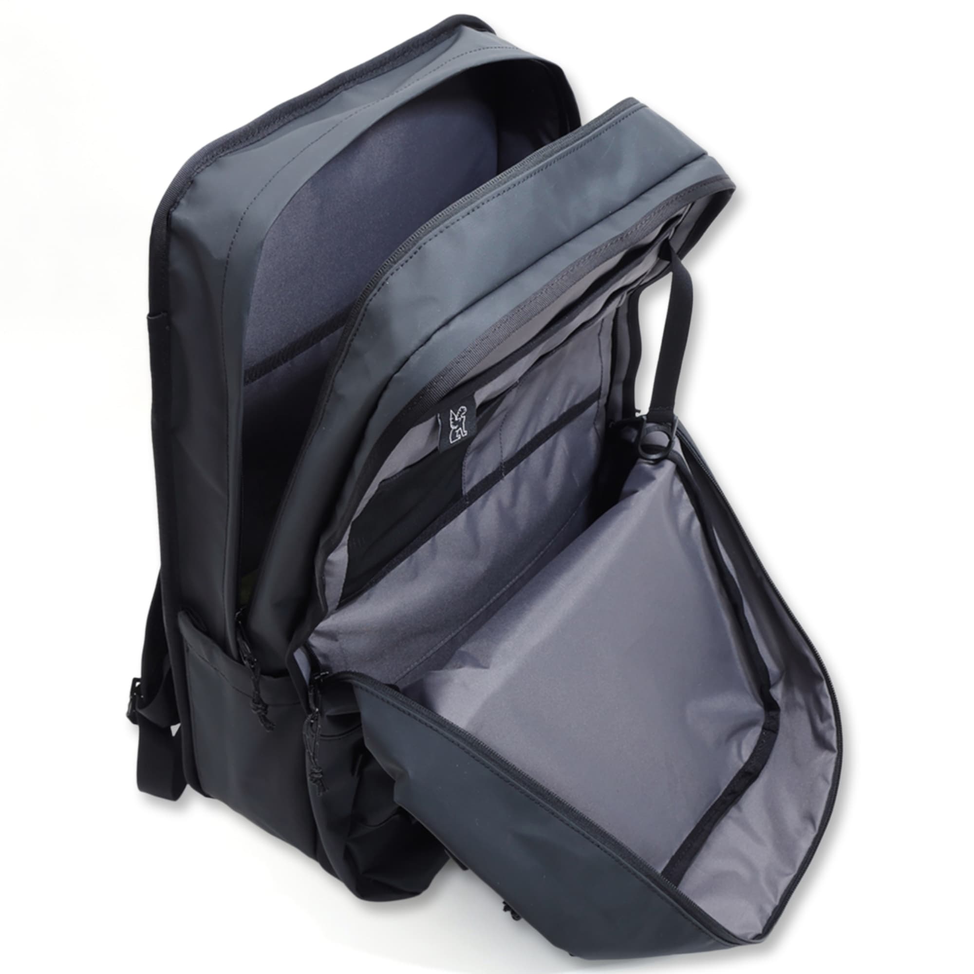 The two compartments of the Cohesive backpack shown in the Black Tarp color