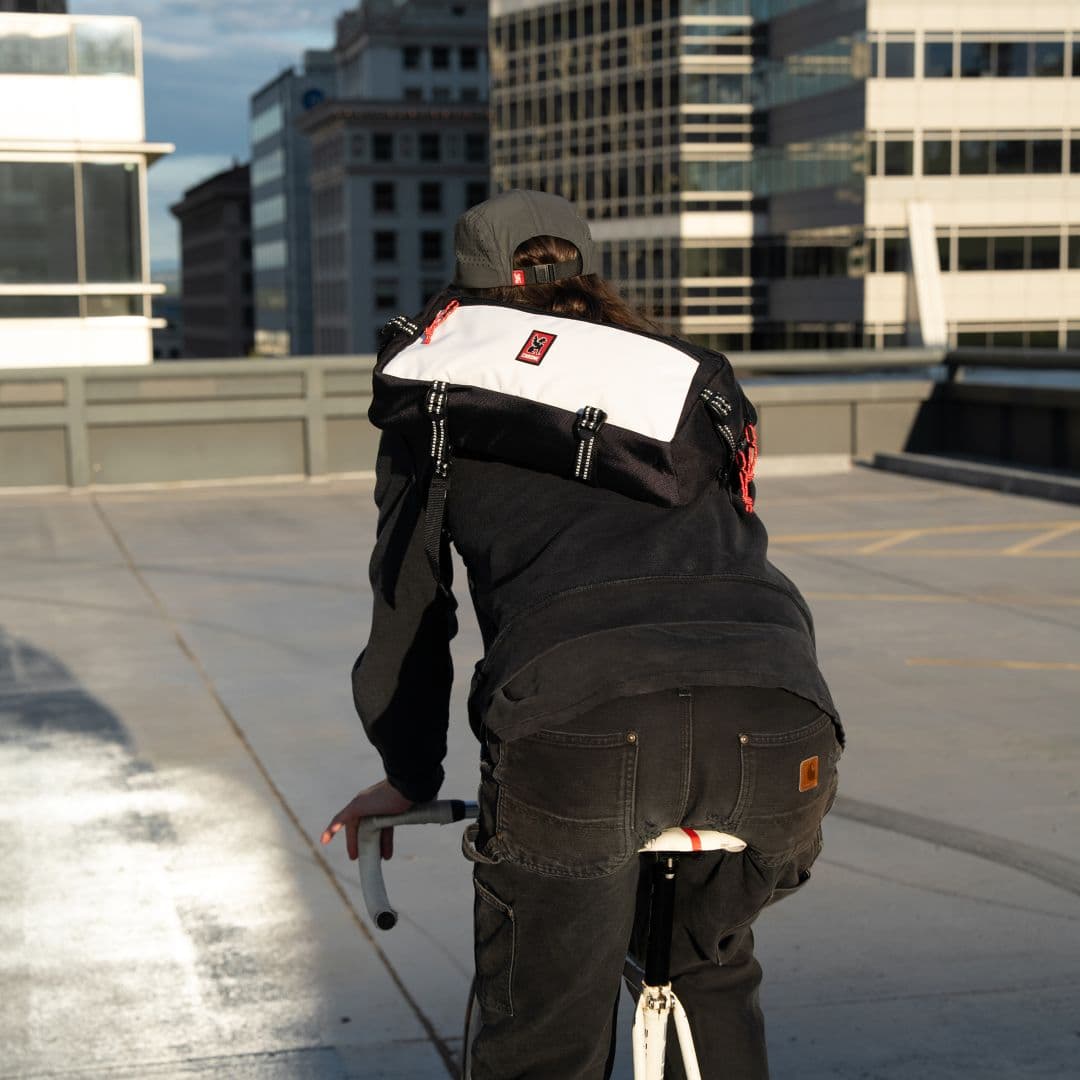 A guy riding his bike wearing the new classic color Kadet Sling