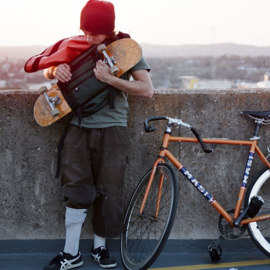 A skater undoing their board from the Citizen Skate Messenger