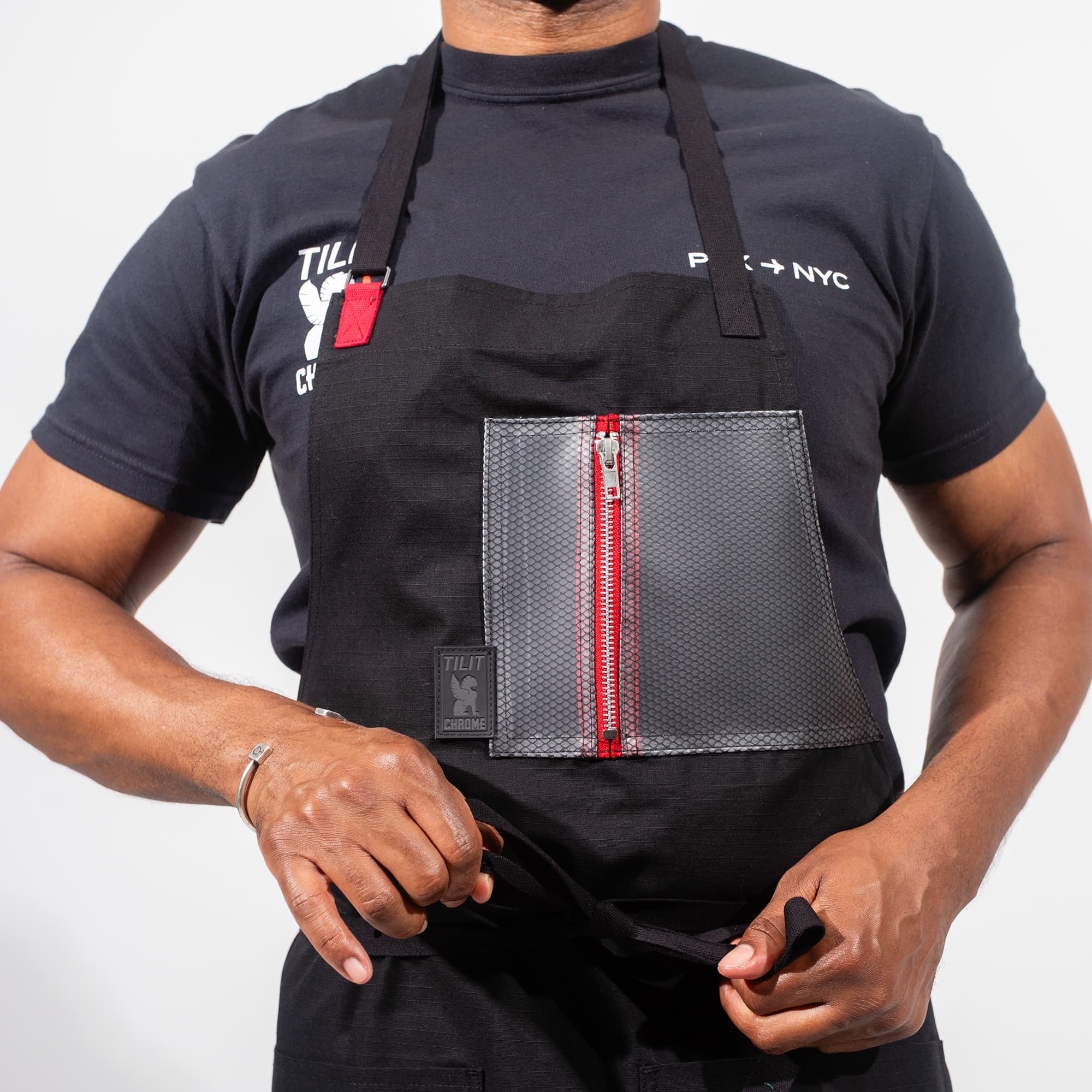 A guy wearing the Chrome x Tilit Chef Apron