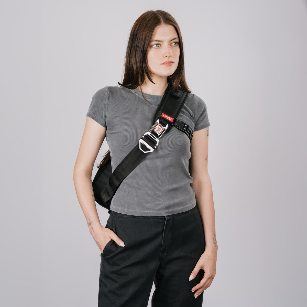 A woman wearing the Kadet Max Sling in Classic Black White #color_classic / black / white