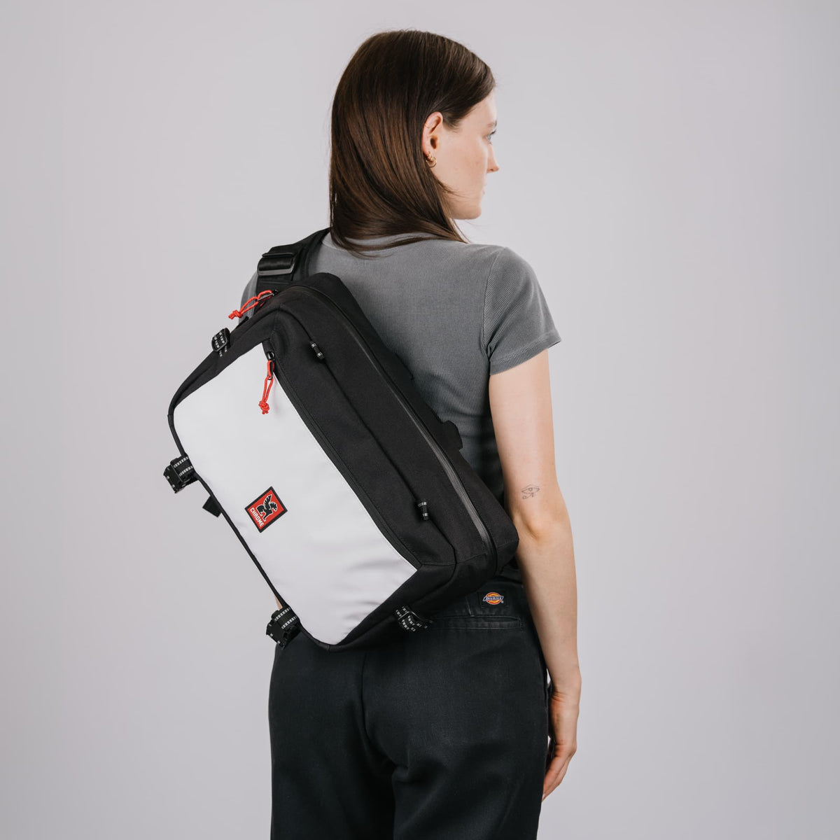 Kadet Max Sling in Classic Black White on the back of a woman #color_classic / black / white