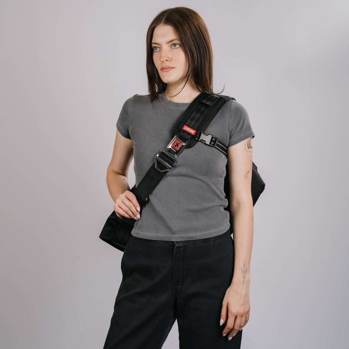 The Citizen 24L Messenger in new Classic Black White on the front of a woman #color_classic / black / white