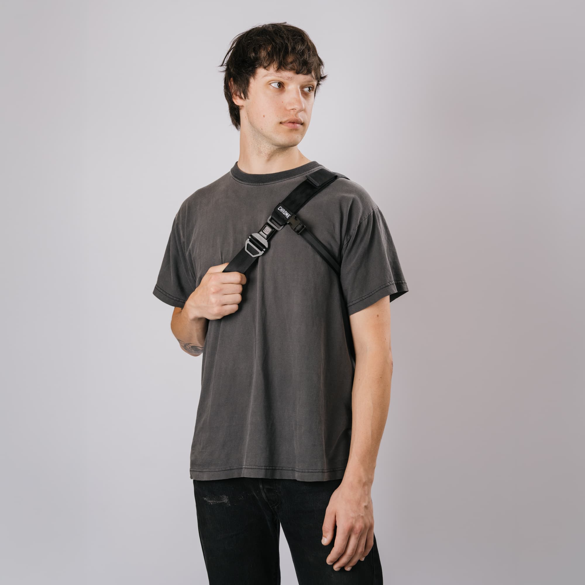 A guy wearing the Barrage 5L Sling in the new Black X2, front strap showing