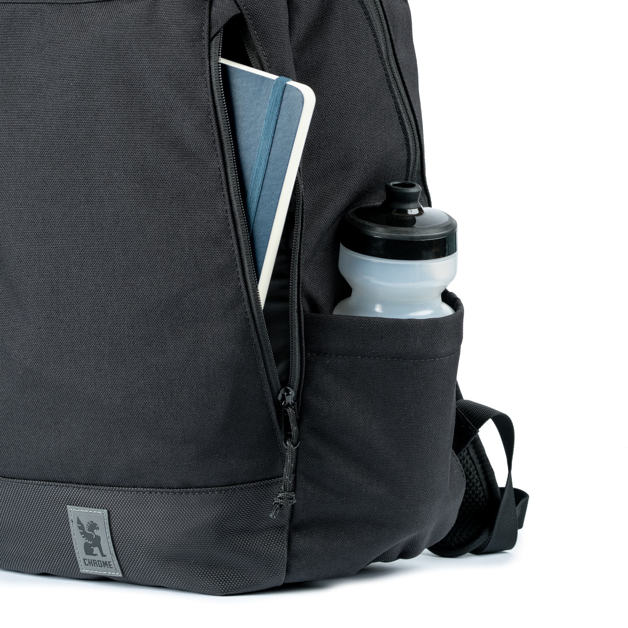 The external side zip pocket of the Recruit 22L Pack with a water bottle in the water bottle side pocket