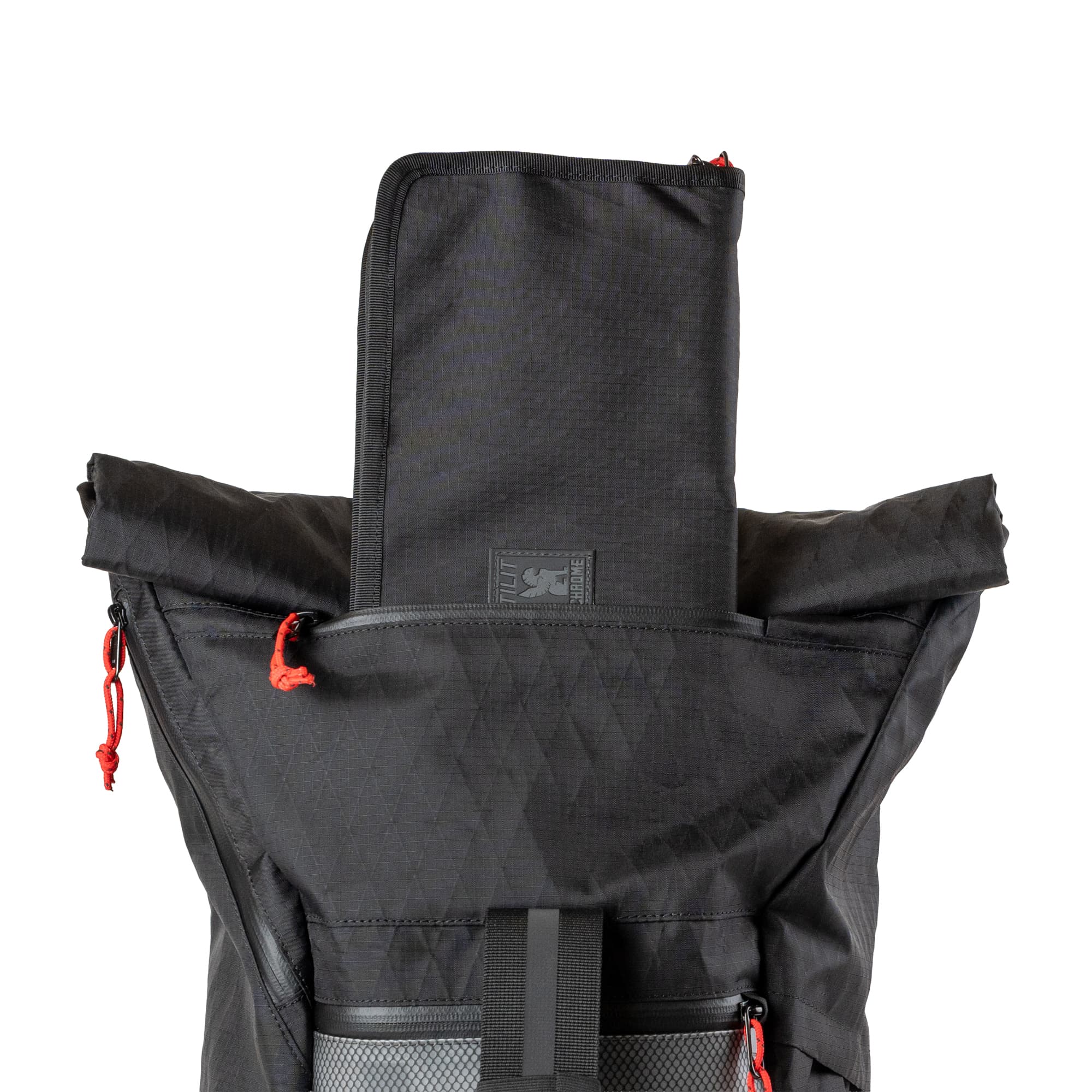 The knife roll coming out of the zipper pocket in the Chrome x Tilit 29L Chef Pack
