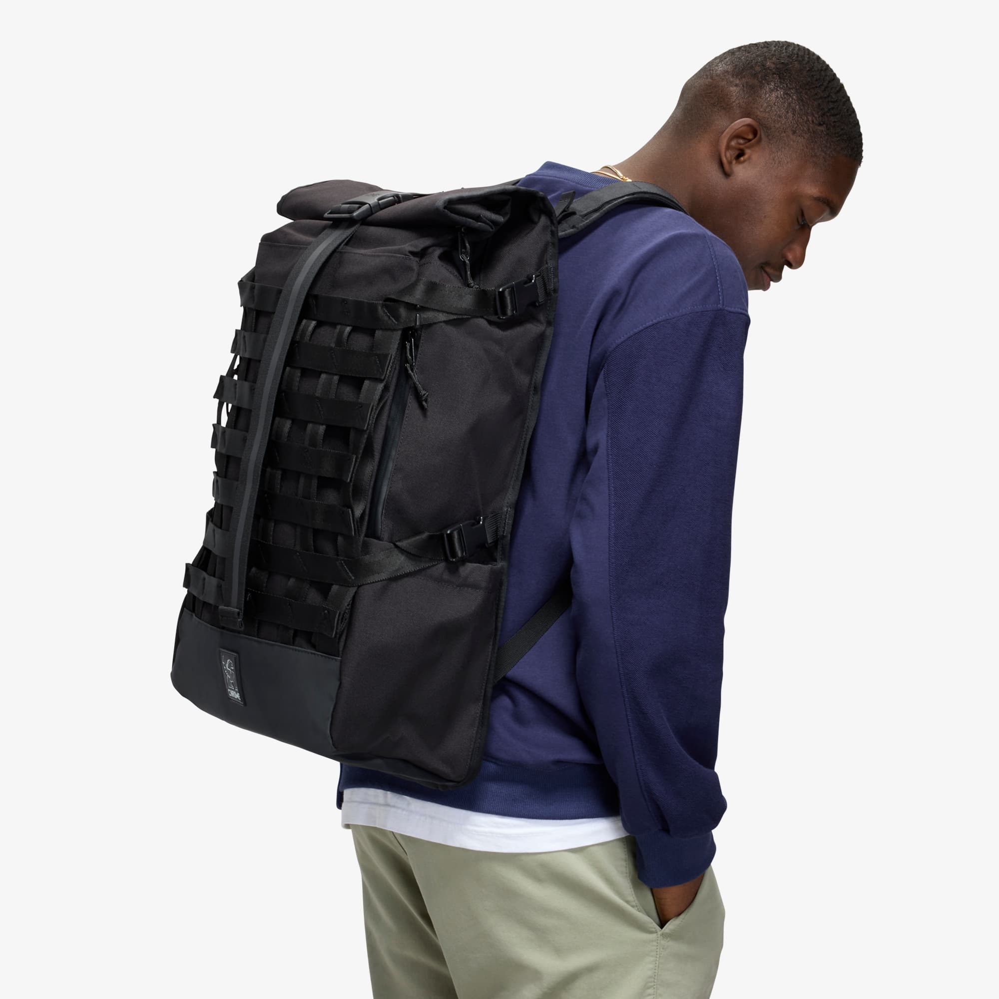 Man wearing the 34L Barrage Backpack side view #color_black