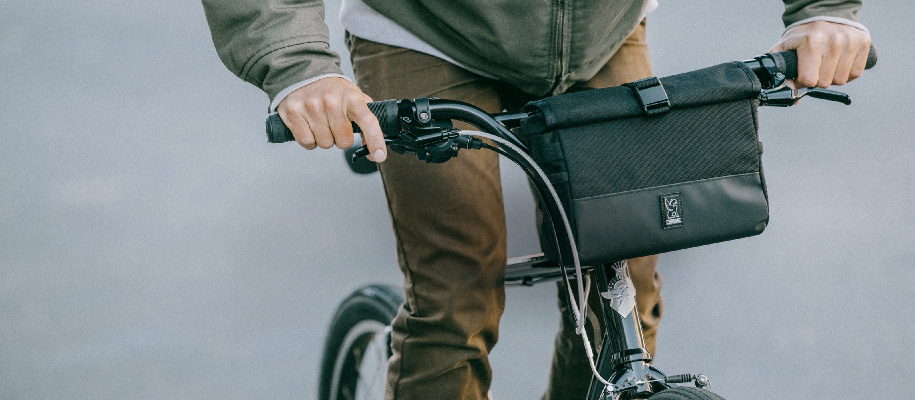 Doubletrack Handlebar Bag on a bike with a guy riding it in a desktop size image