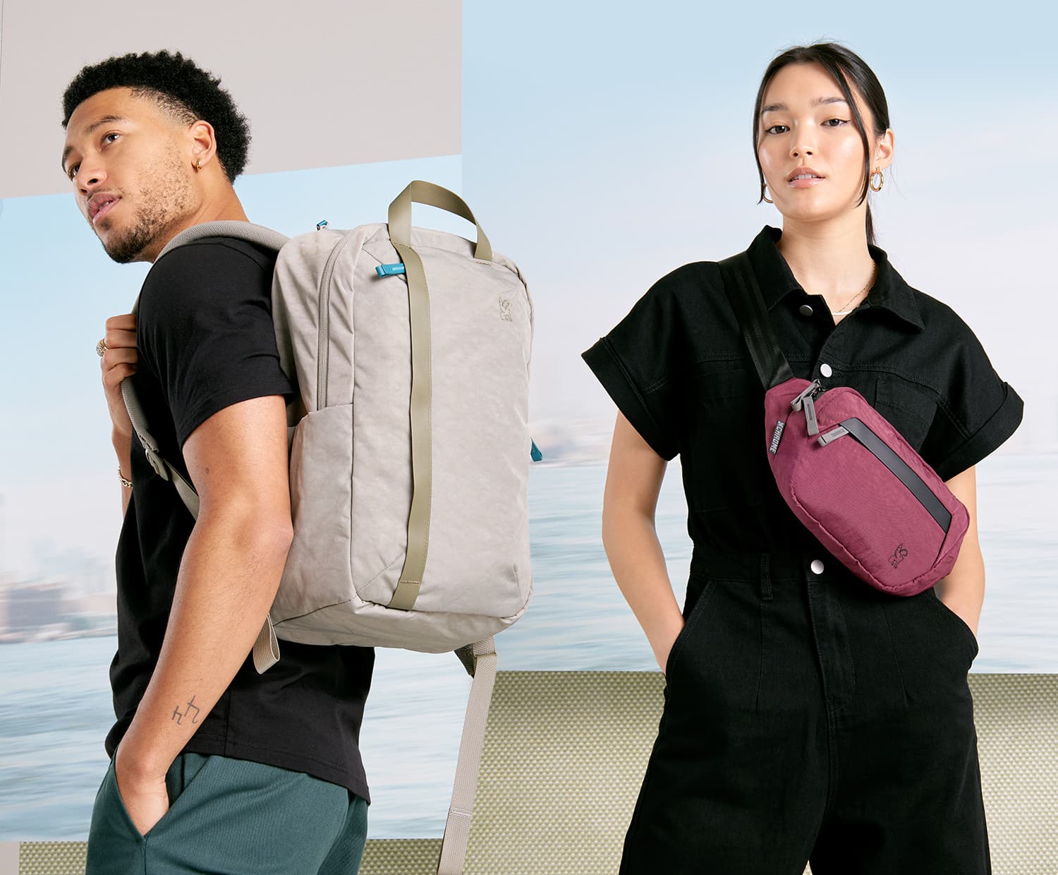 Man and a woman wearing the district collection bags
