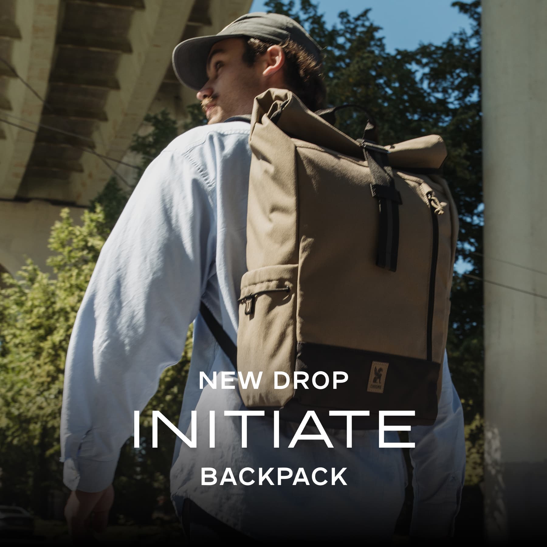 A guy wearing the new Initiate 26L Pack in Coyote brown