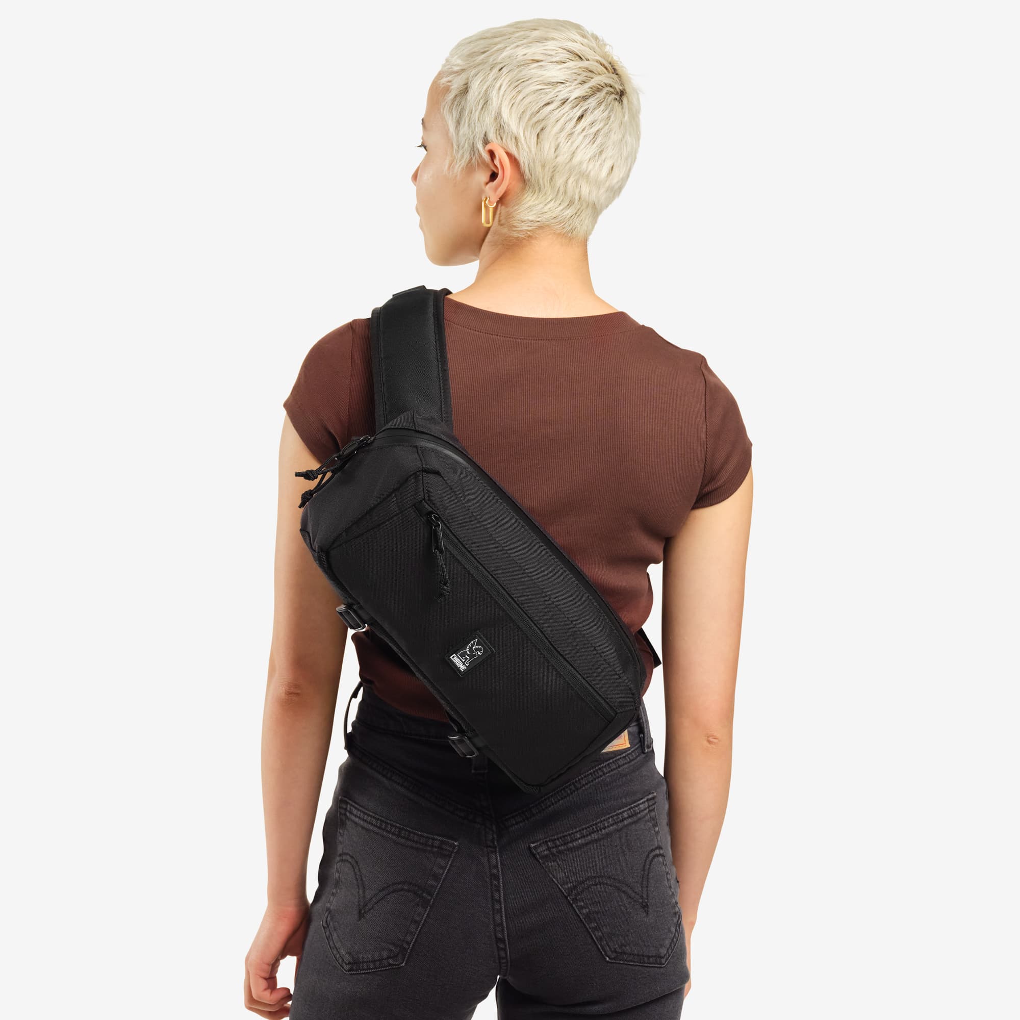 Woman wearing the Mini Kadet in black #color_heritage suede