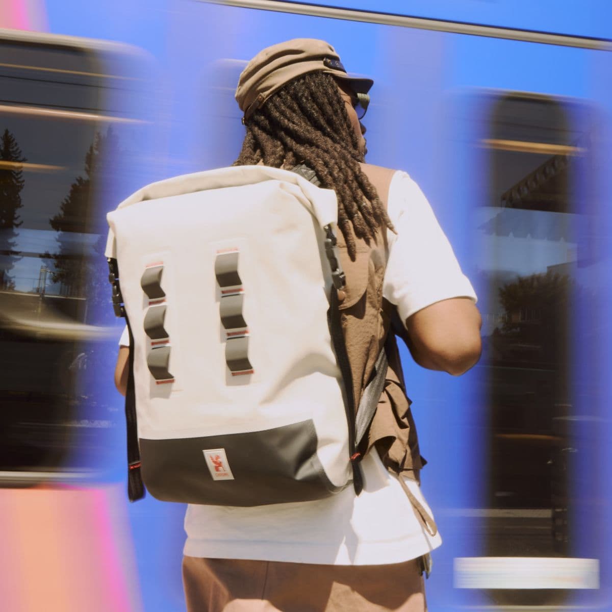 A guy waiting for the train in the Future White Urban Ex Pack 30L