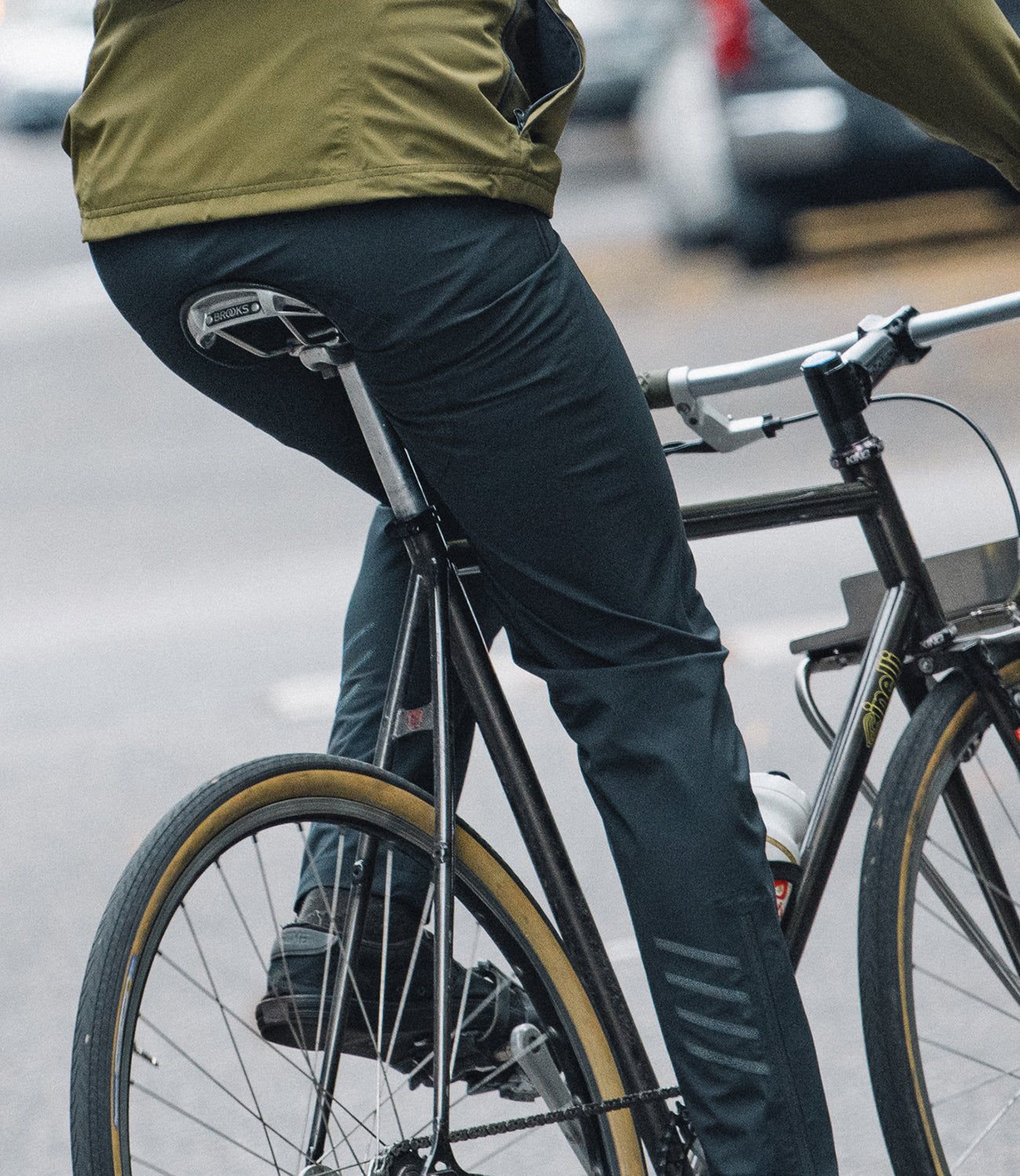 Storm rain pant shown on a person riding a bike in a mobile size image