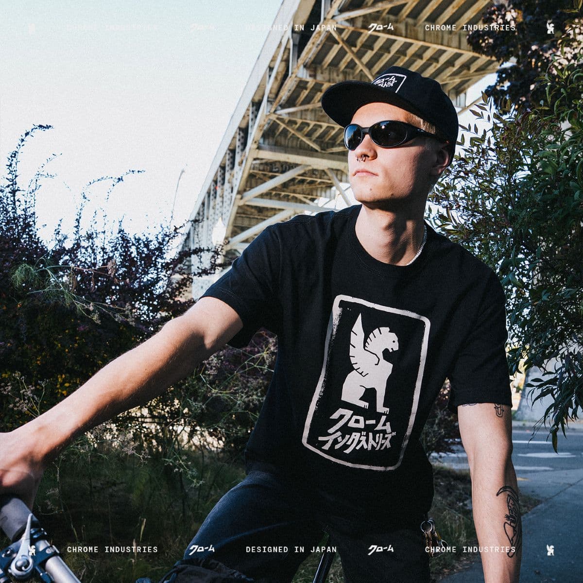 A guy wearing the Japanese Hat and Shirt riding a bike