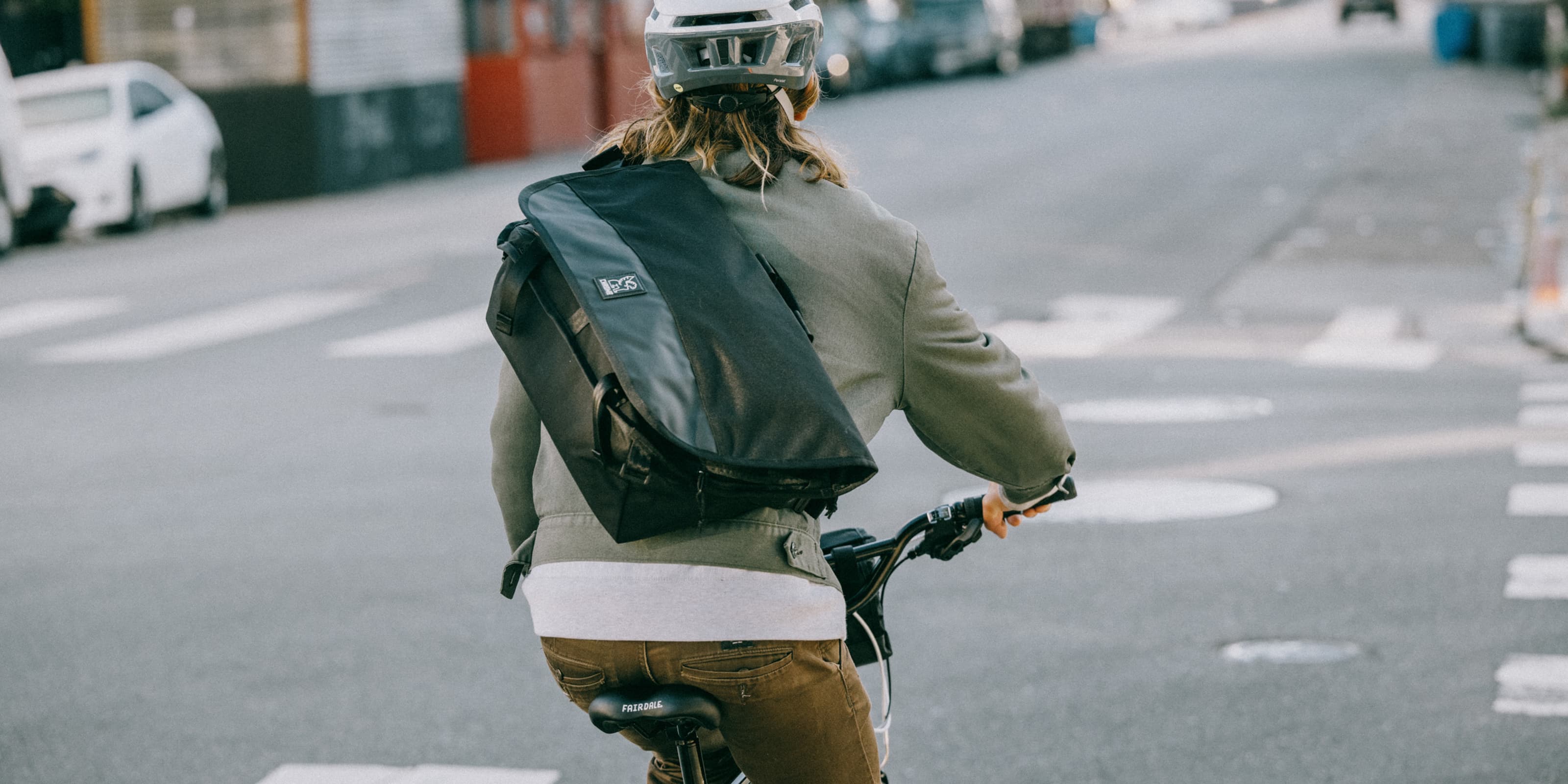 Water-resistant Buran III Messenger bag in black worn by a person