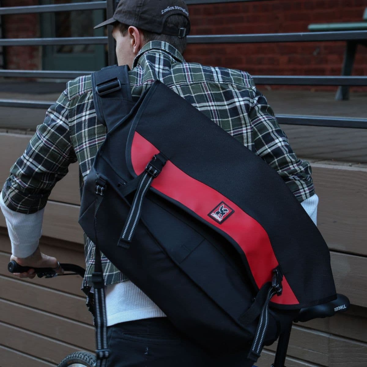 A guy riding a bike wearing the new Metropolis Messenger