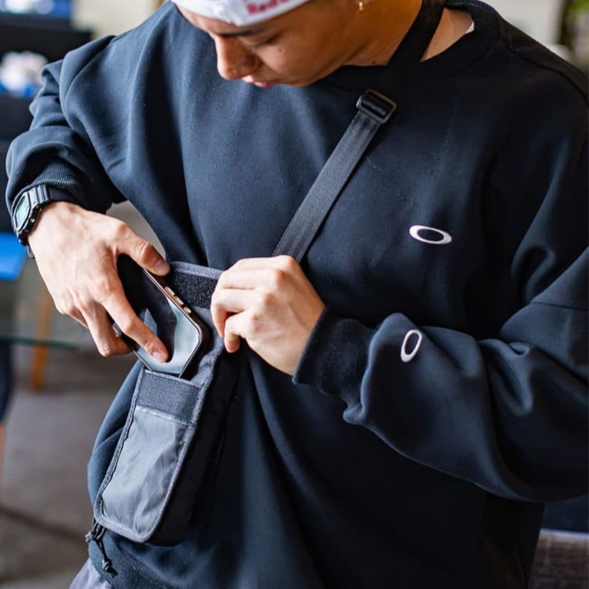 Rim Nakamura adding his phone to the Travel Tech Pouch