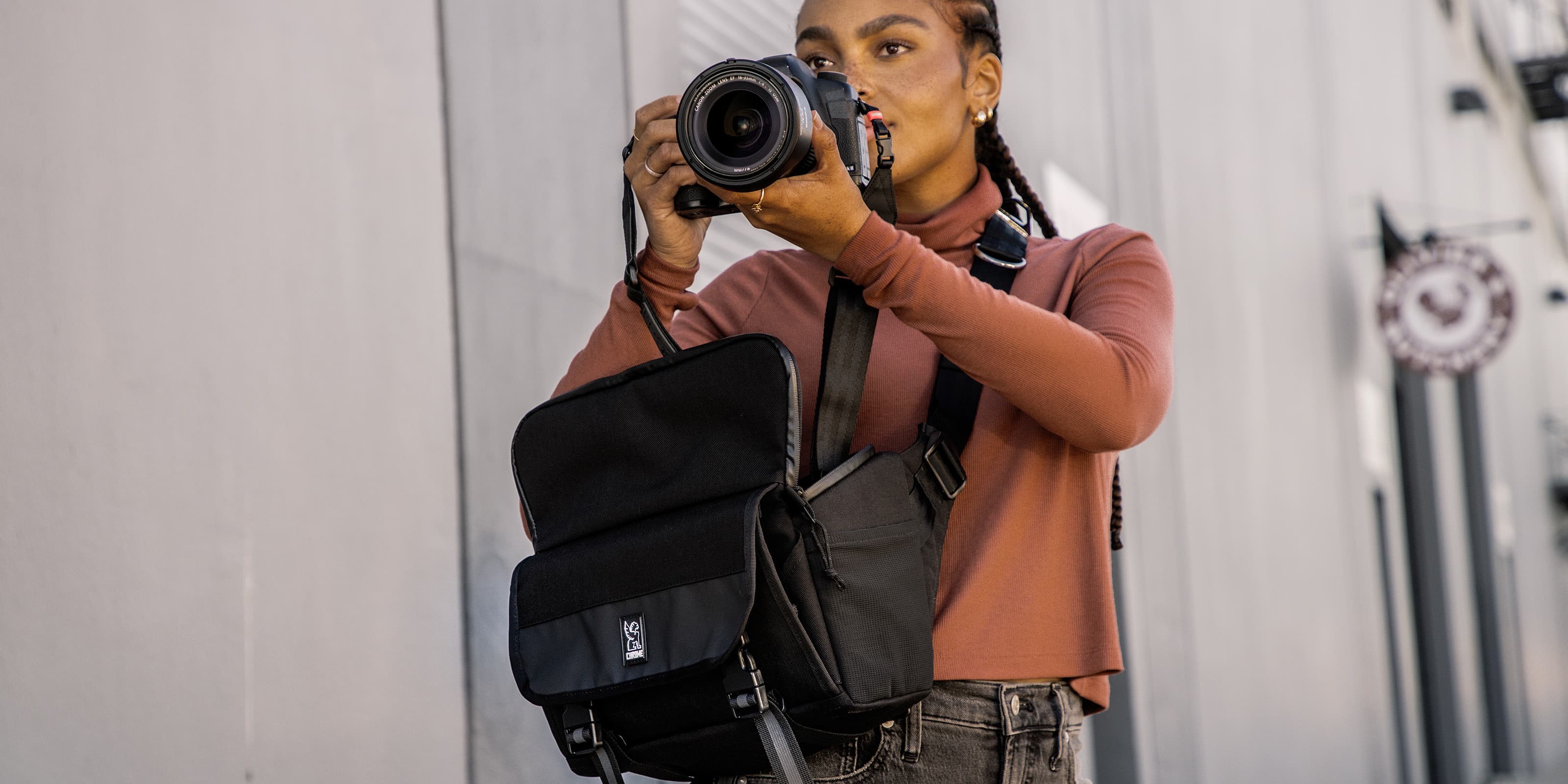 Niko Camera Sling worn by a photographer taking a photo desktop size image