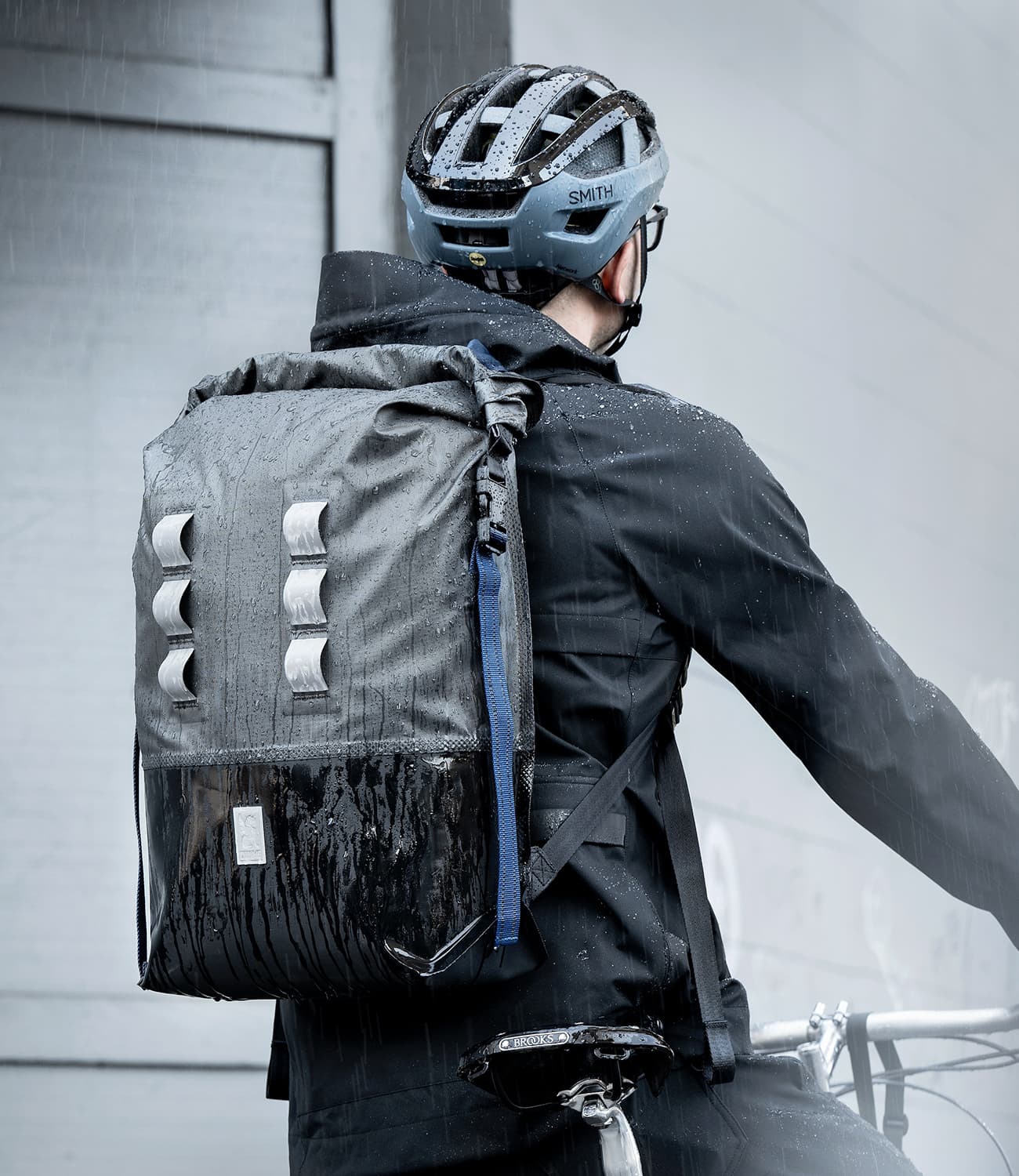 Urban Ex 30L Backpack worn by a guy on a bike in the rain mobile image size