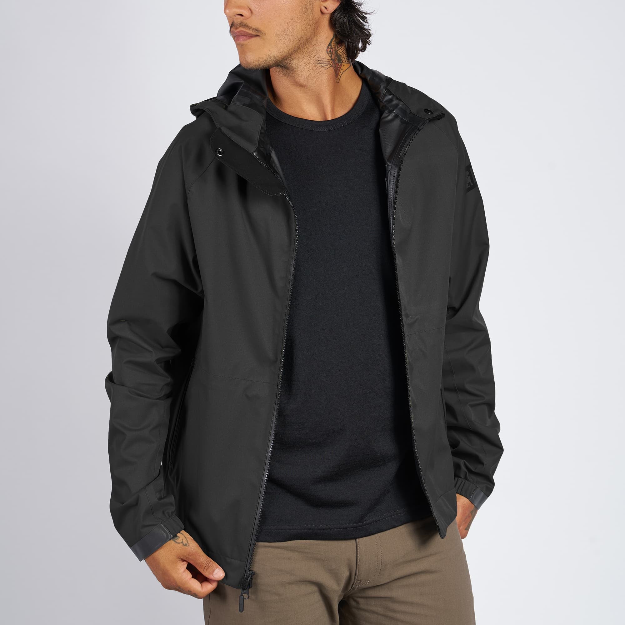 Waterproof rain jacket in black worn by a man
