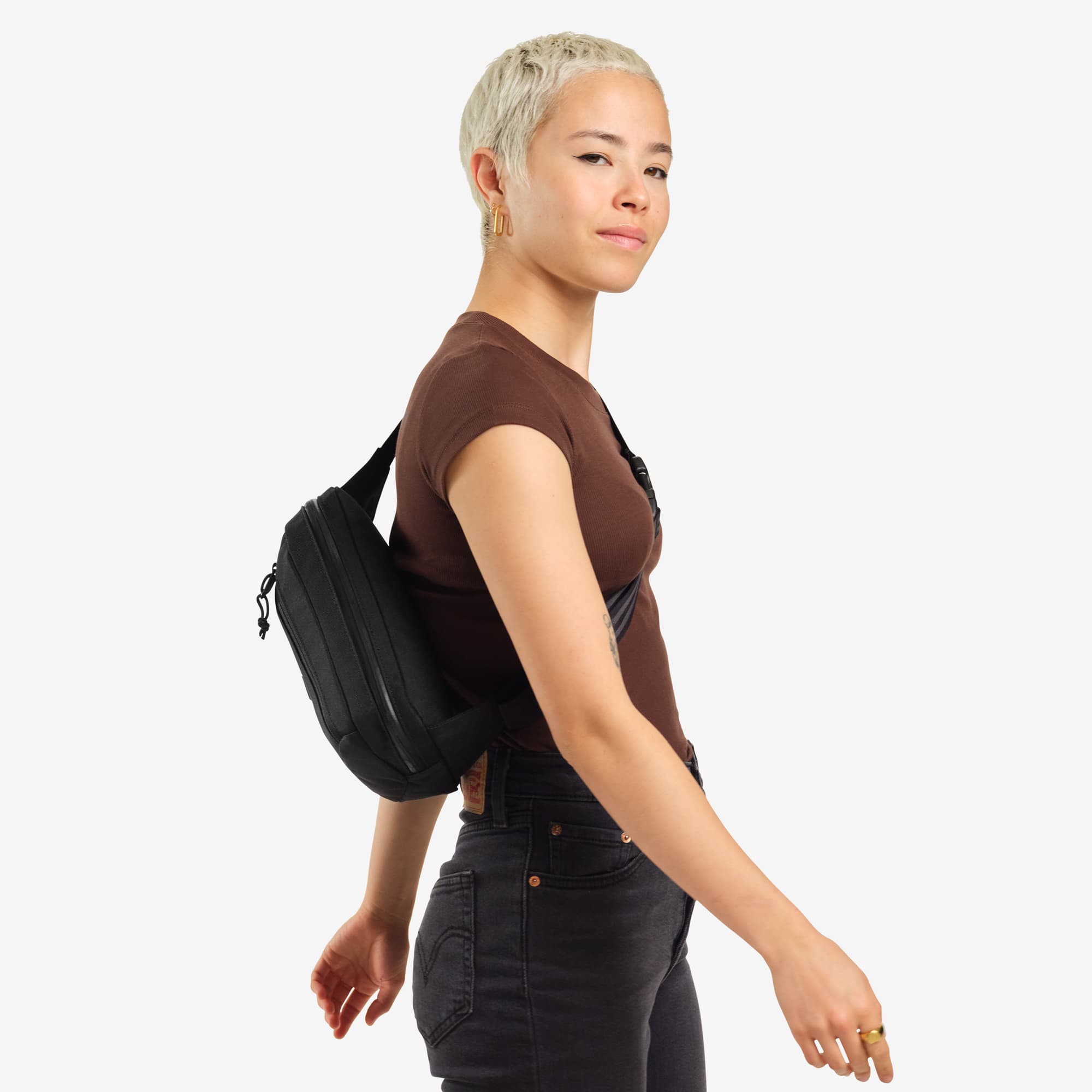 Ziptop Waistpack sling in black worn by a woman