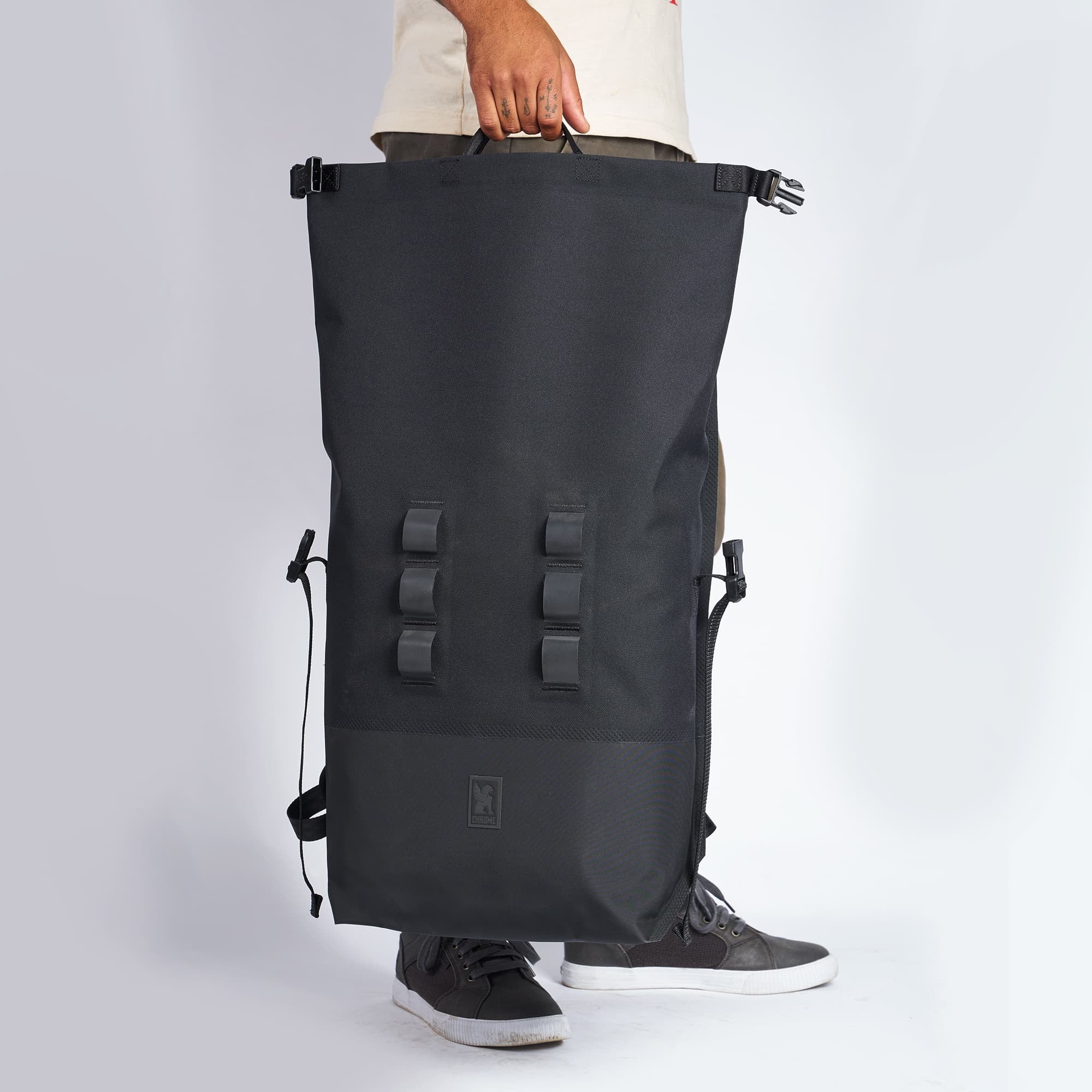 Waterproof 30L rolltop backpack in black carry handles #color_black