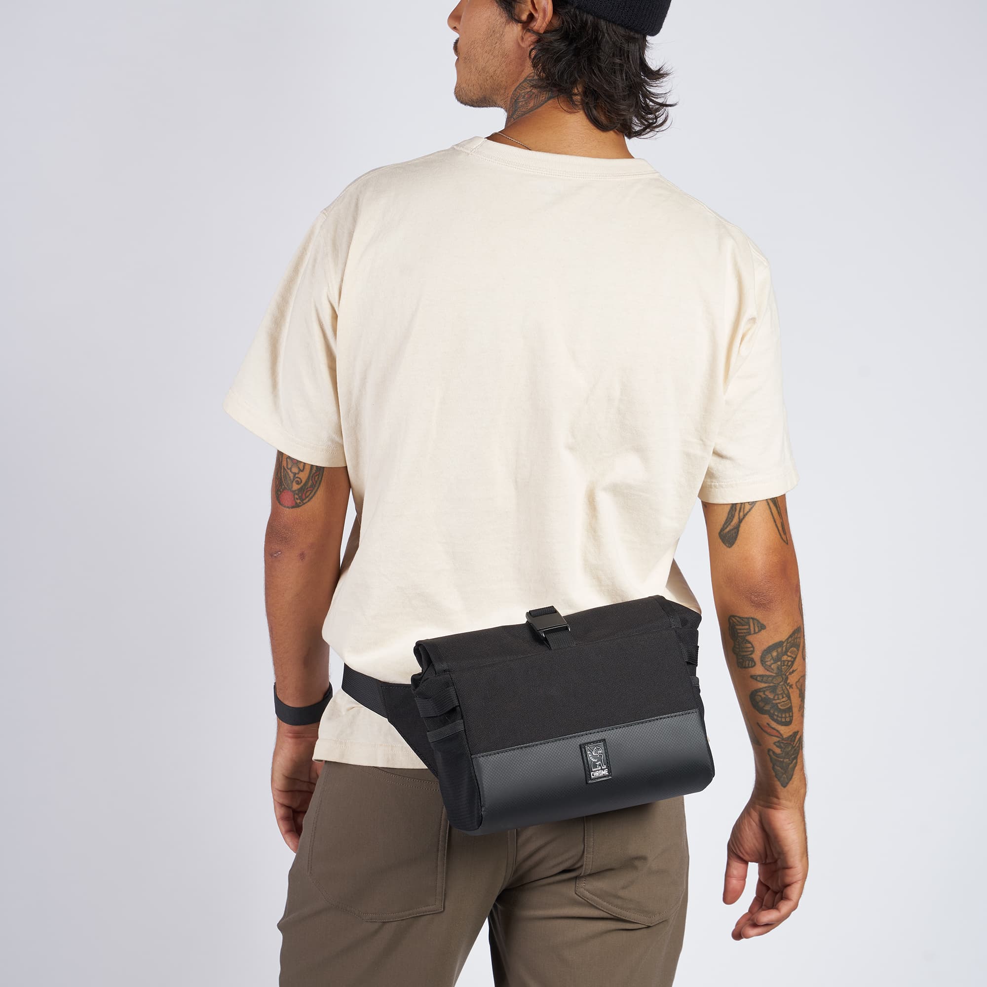 5L Doubletrack Handlebar Sling in black on a man as a hip pack