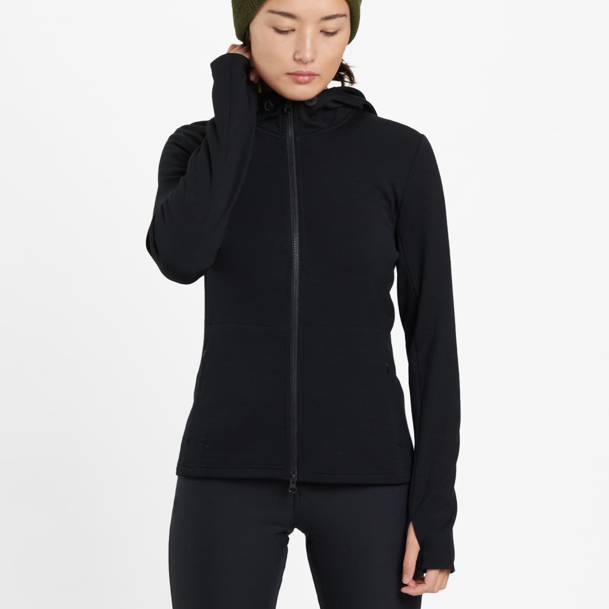 Women's Merino blend performance hoodie in black worn by a woman