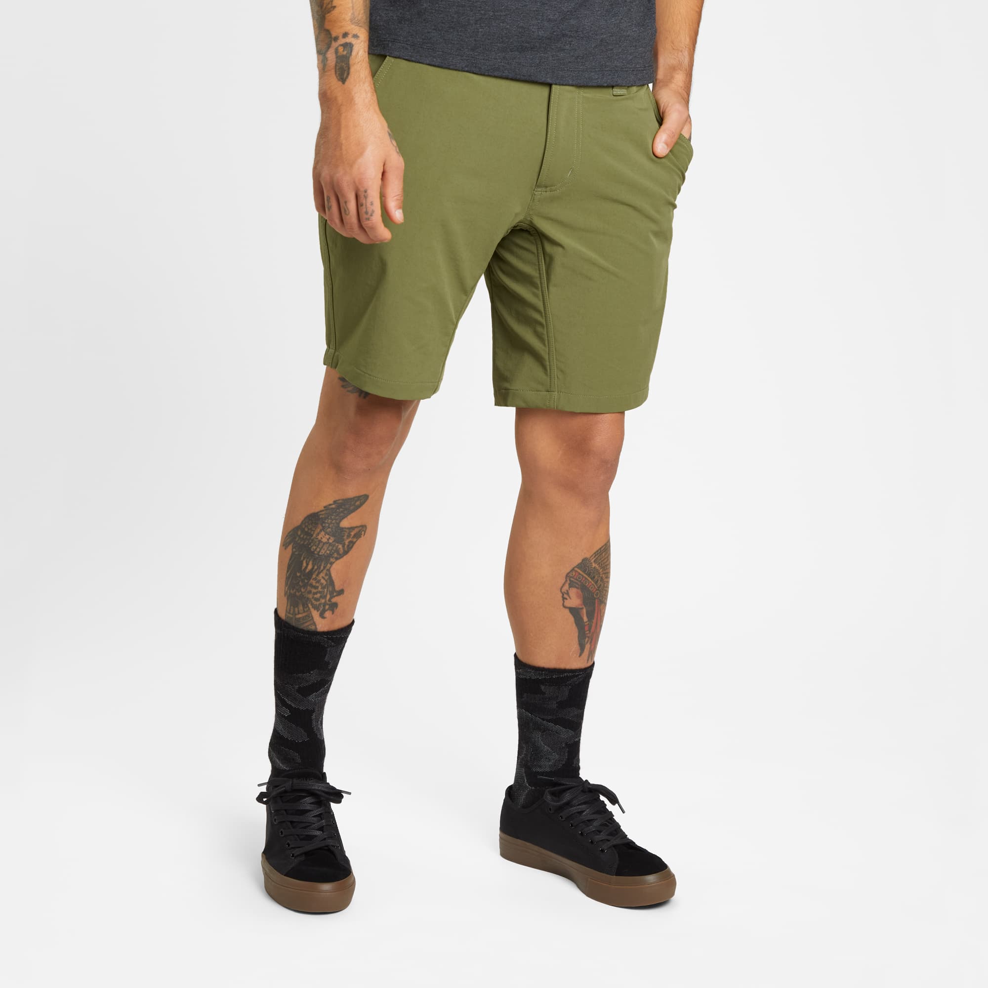 Men's tech Folsom Mid Short in green worn by a man #color_olive branch