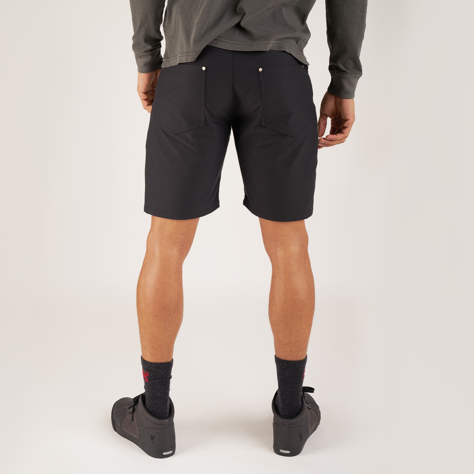 Men's Madrona 5-pocket short in black worn by a man back view #color_black