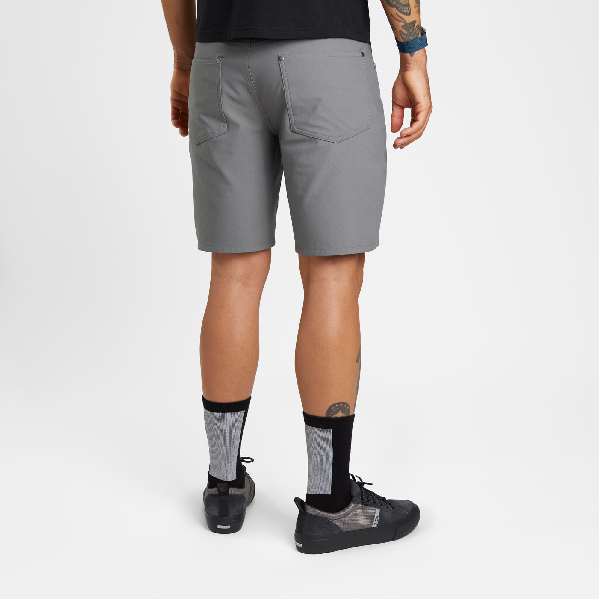 Men's Madrona tech 5-pocket short in grey worn by a man back view #color_castle rock