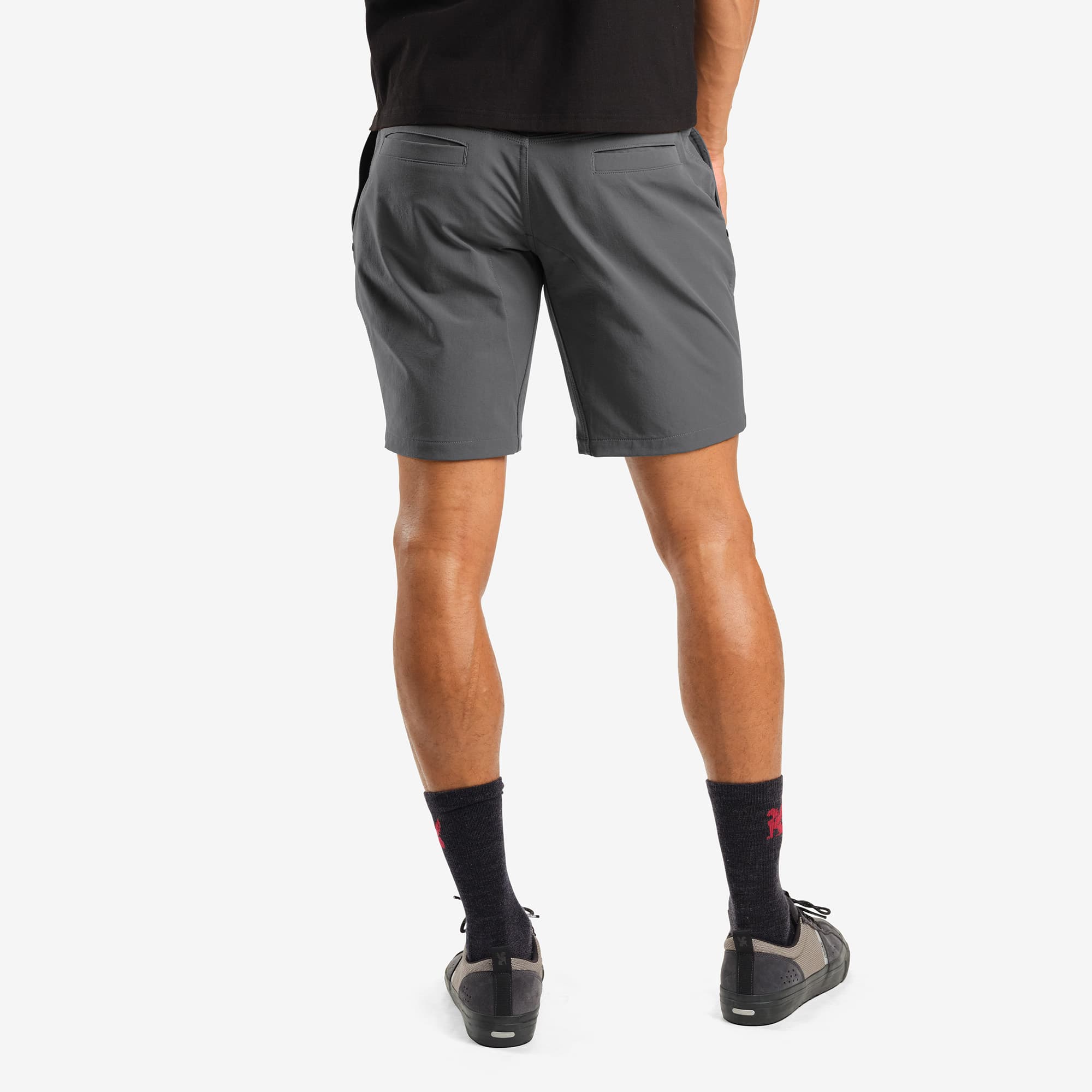 Men's tech Folsom Mid Short in grey worn by a man back view #color_castle rock