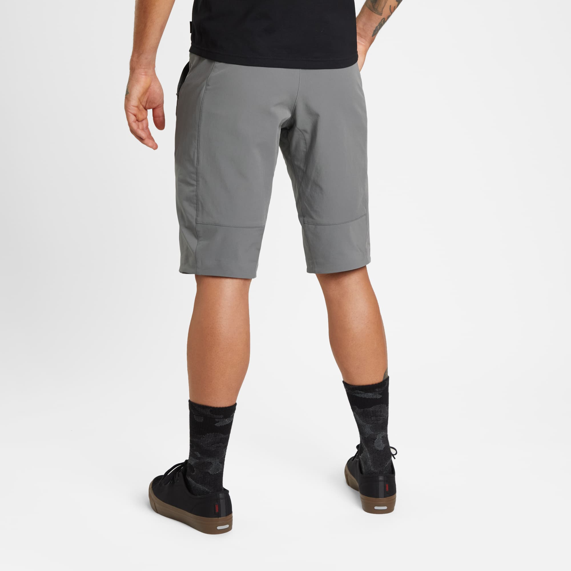 Men's tech Sutro Short in grey worn by a man back view #color_castle rock