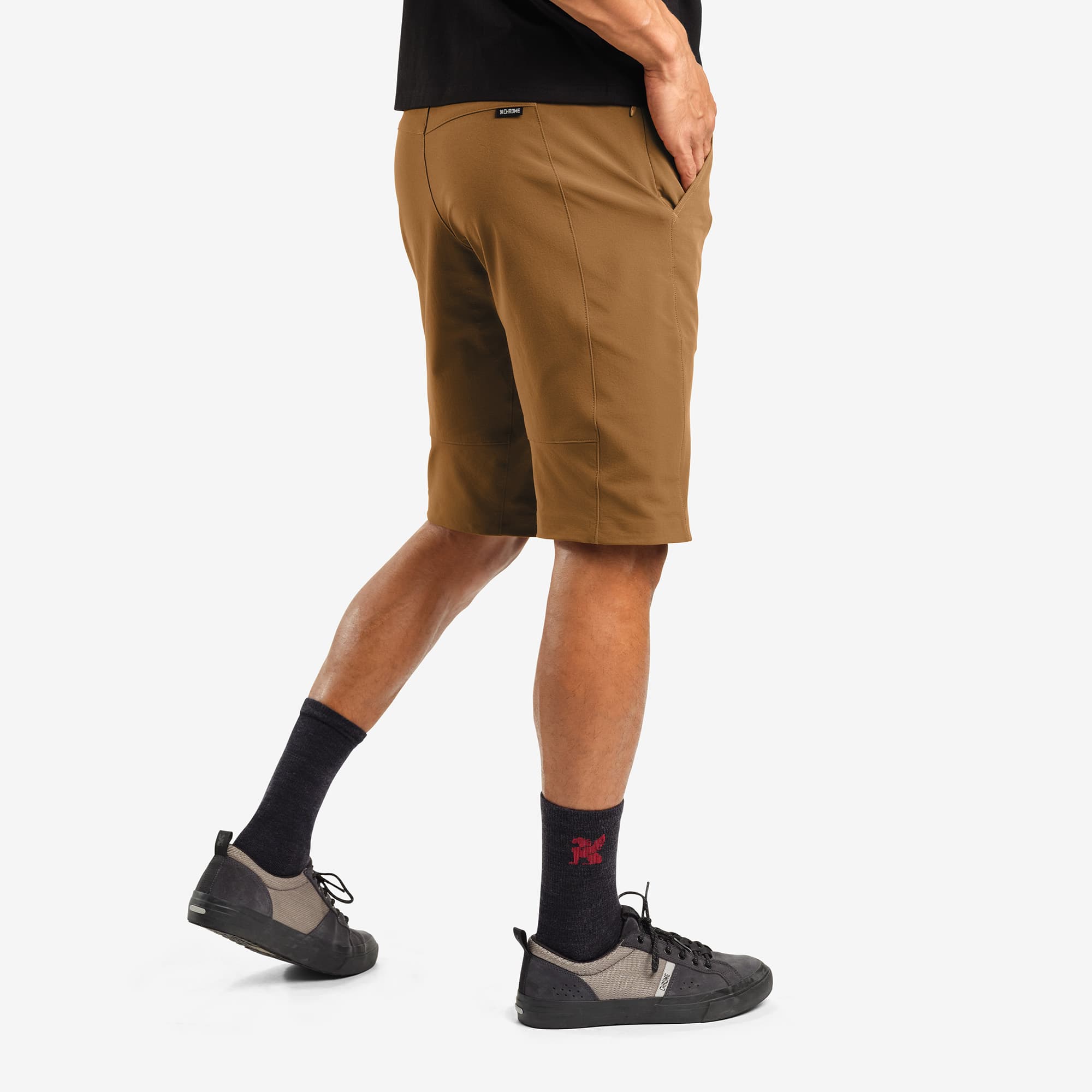 Men's tech Sutro Short in brown worn by a man side view #color_monks robe