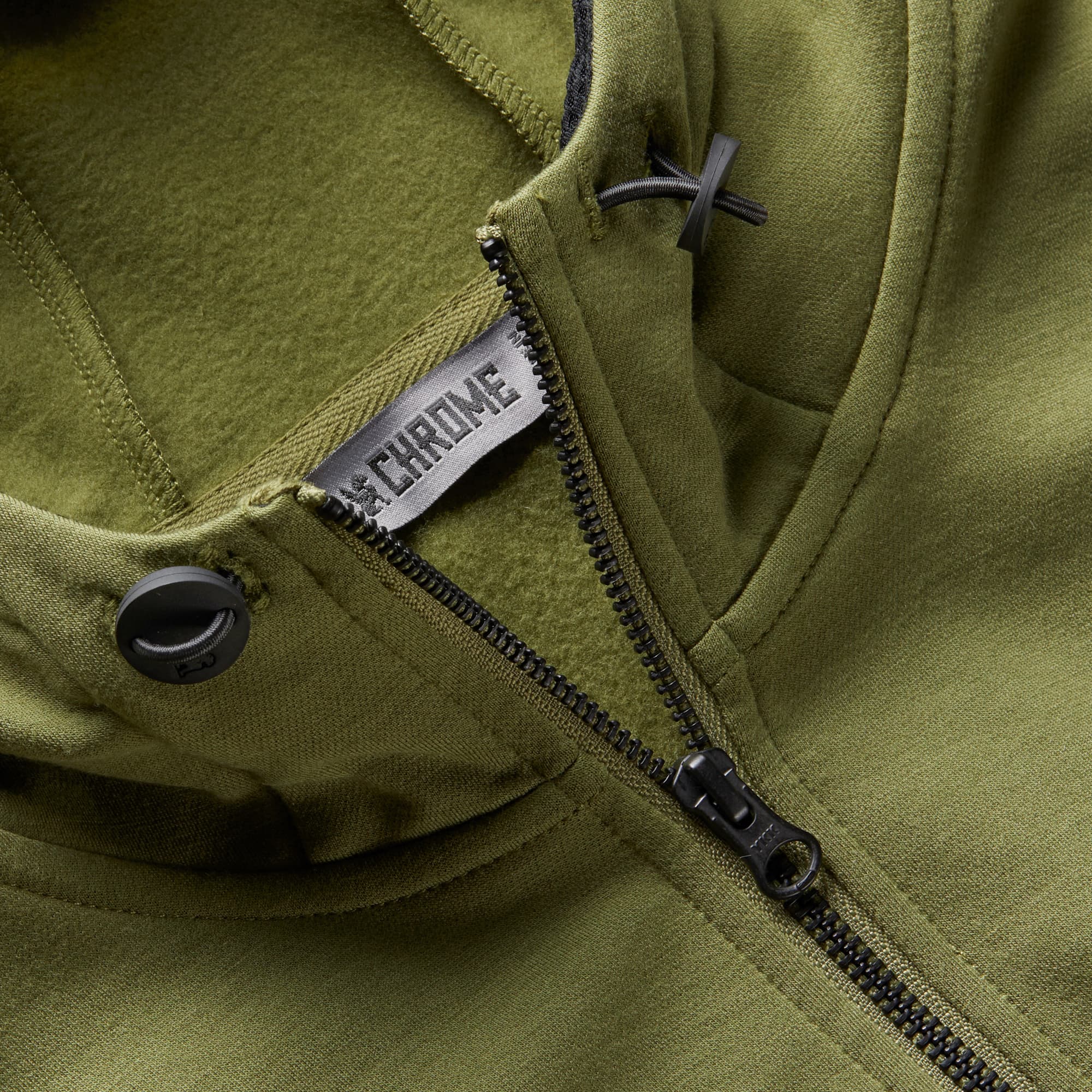 Men's merino blend hoodie in green hood toggle detail #color_olive branch