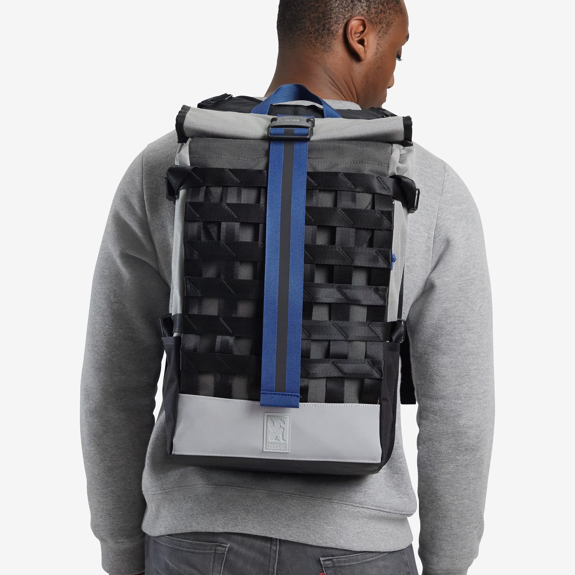 Grey reflective Barrage Cargo Backpack on a mans back #color_fog