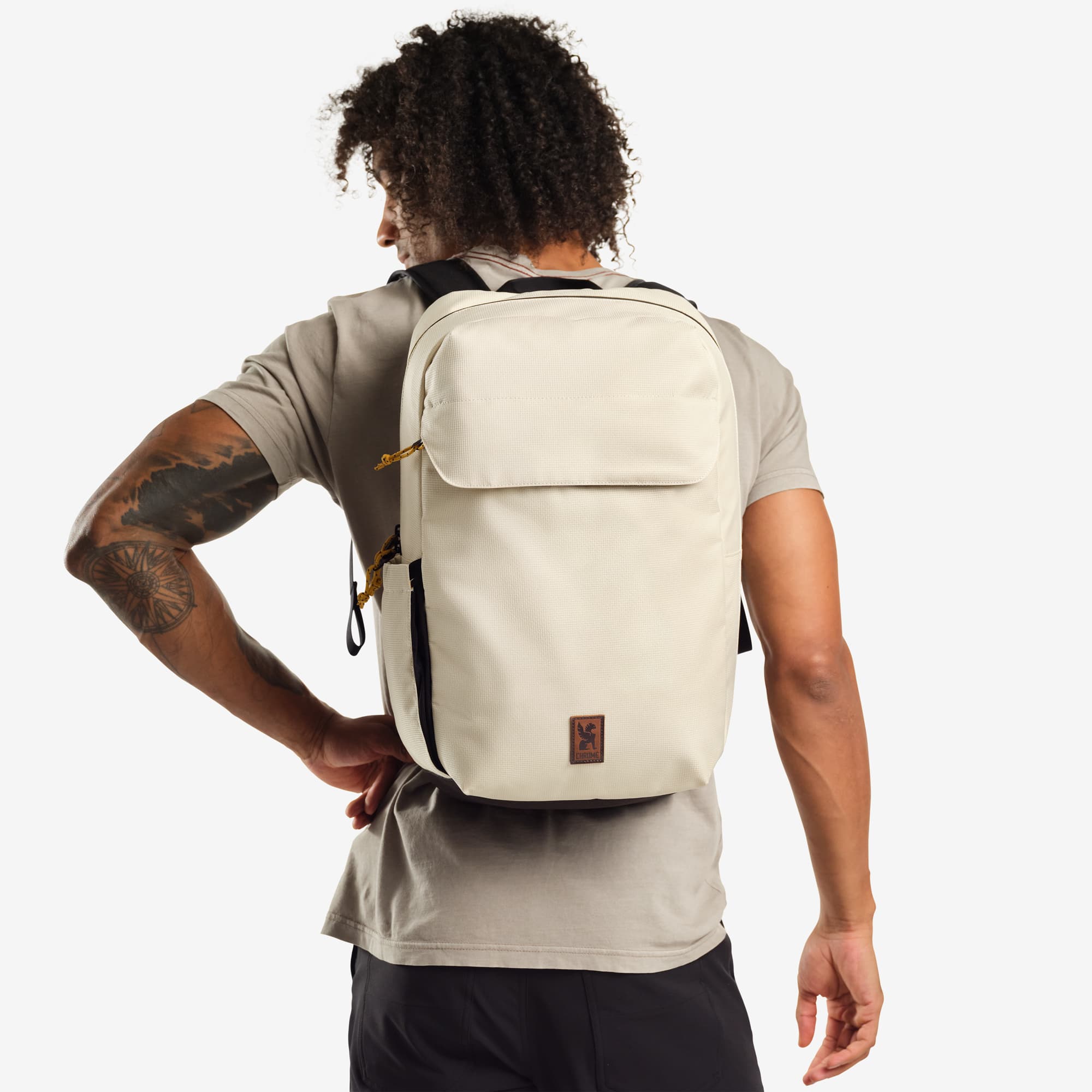 Ruckas 23L Backpack in natural worn by a man #color_natural