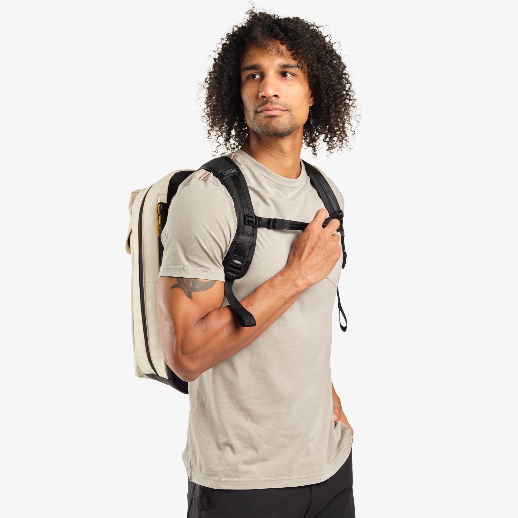 Ruckas 23L Backpack in natural worn by a man front view #color_natural