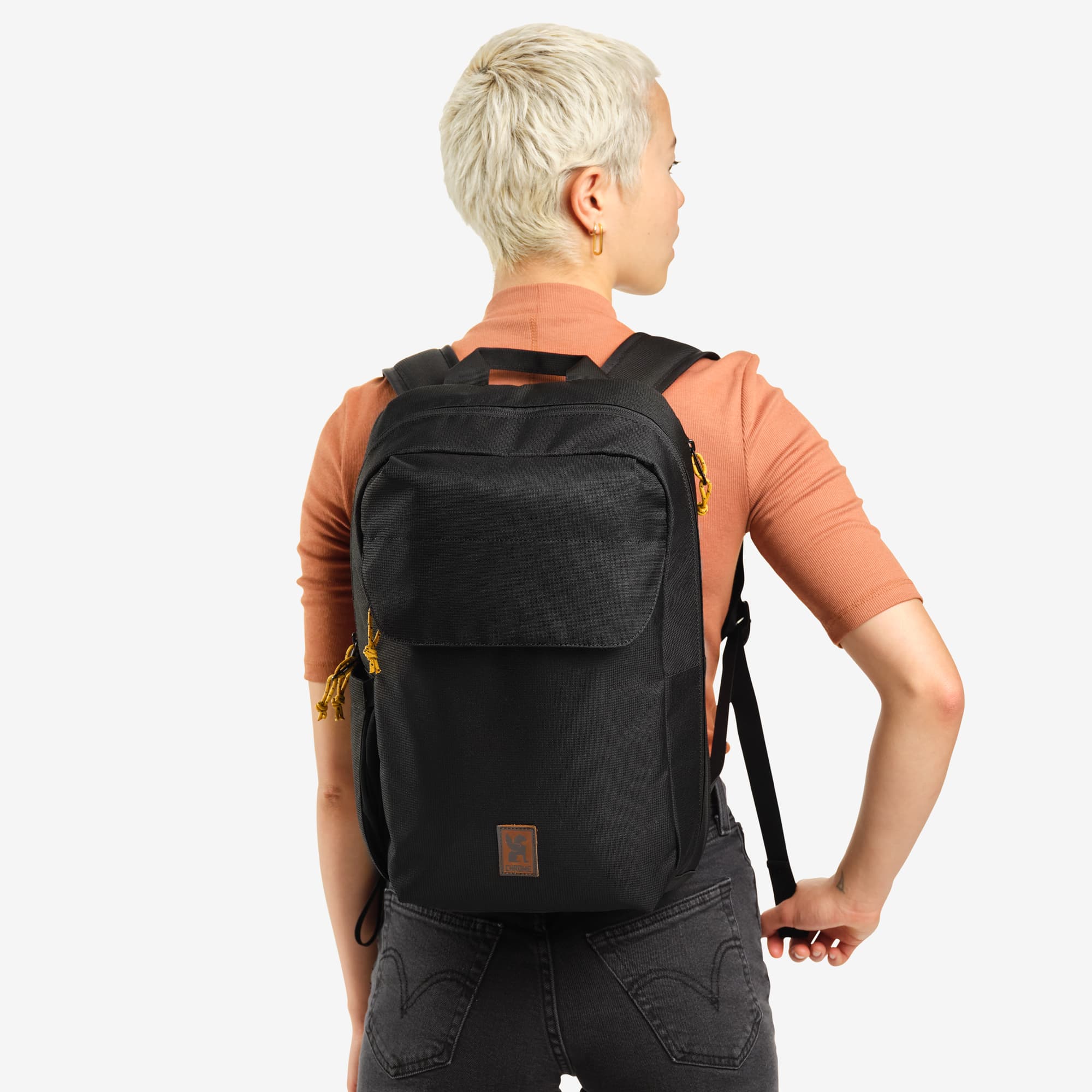Ruckas 14L Backpack in black worn by a woman #color_black