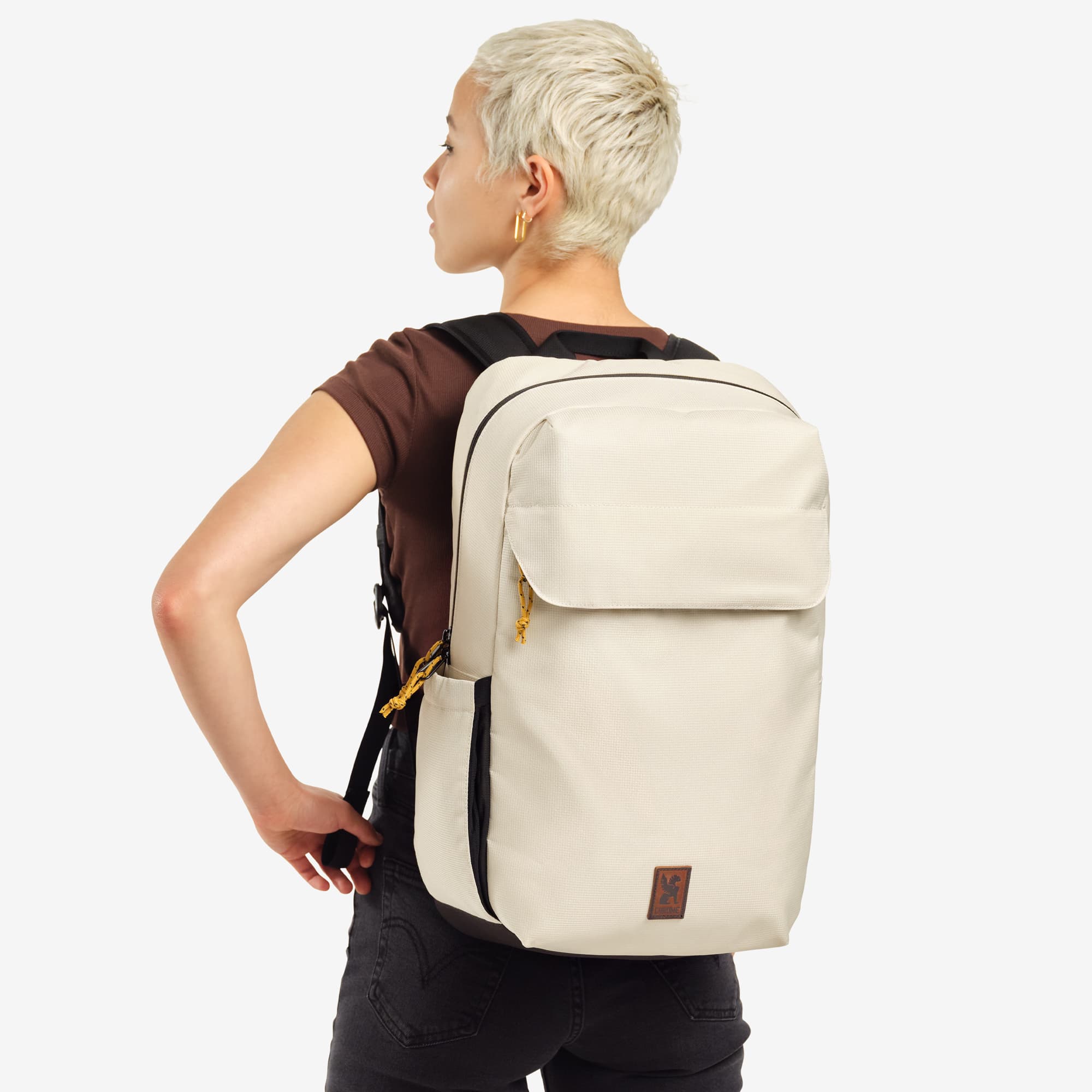 Ruckas 23L Backpack in natural worn by a woman #color_natural
