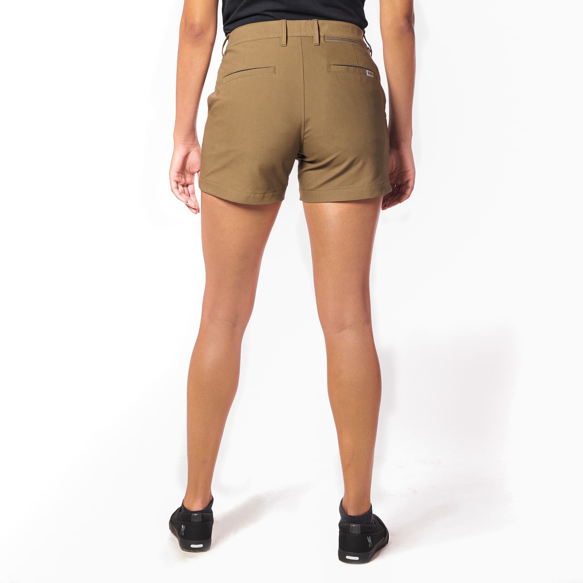 Women's Seneca Short in tan worn by a woman back view #color_stone grey
