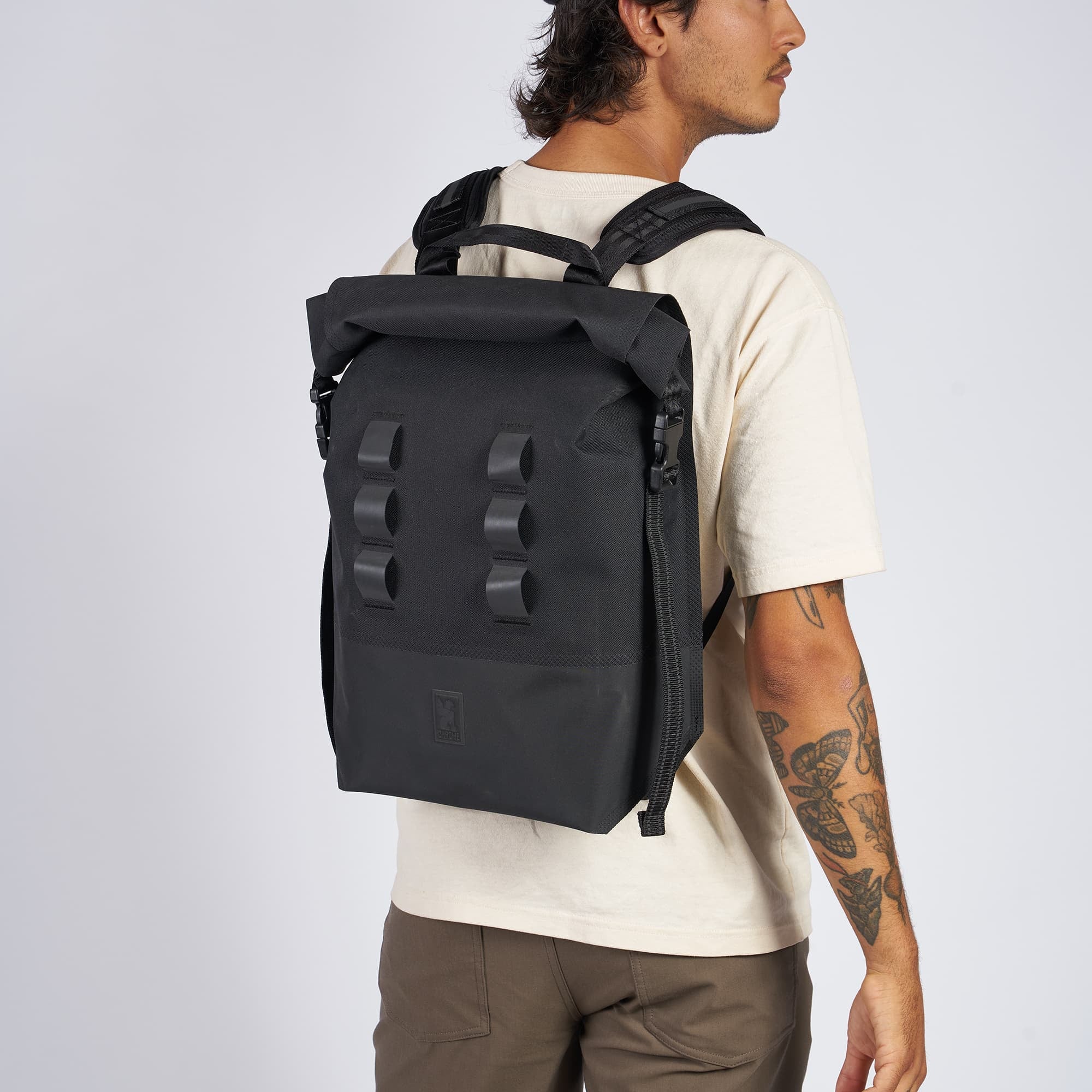 Waterproof 20L backpack in black worn by a man