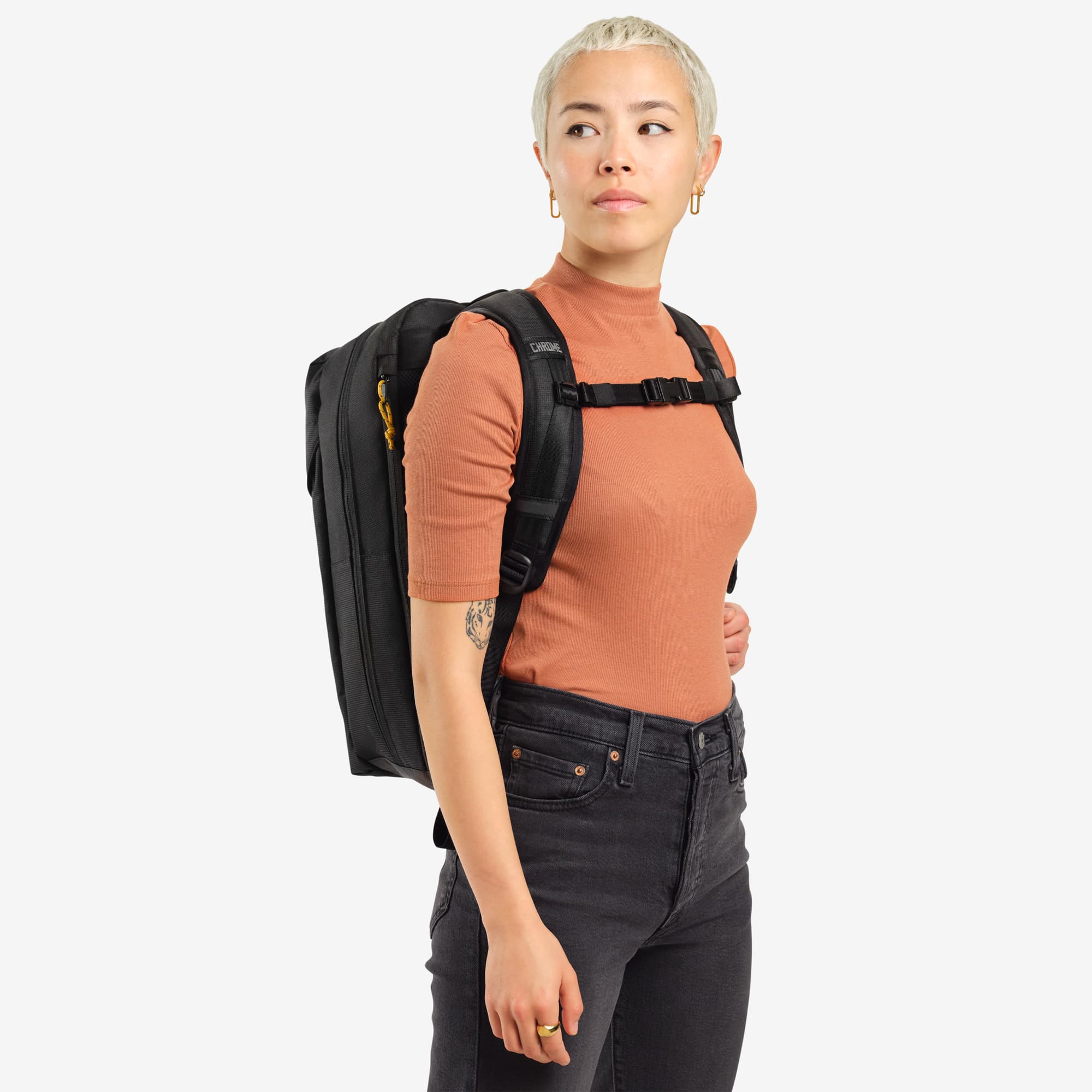 Ruckas 23L Backpack in black worn by a woman side view #color_black