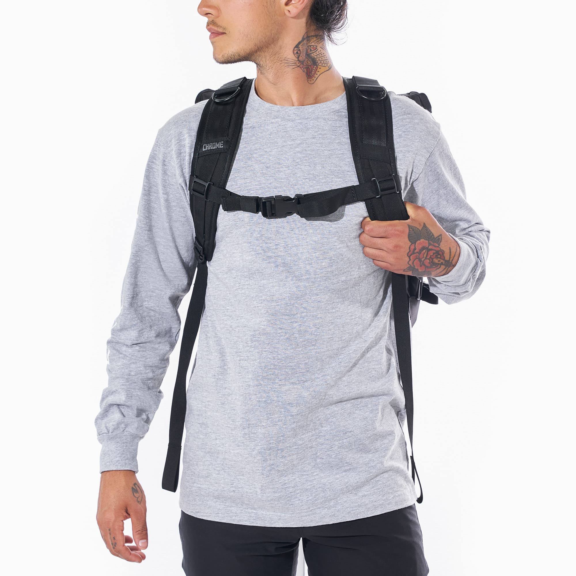 Warsaw medium size flap backpack in black front view as worn by a man