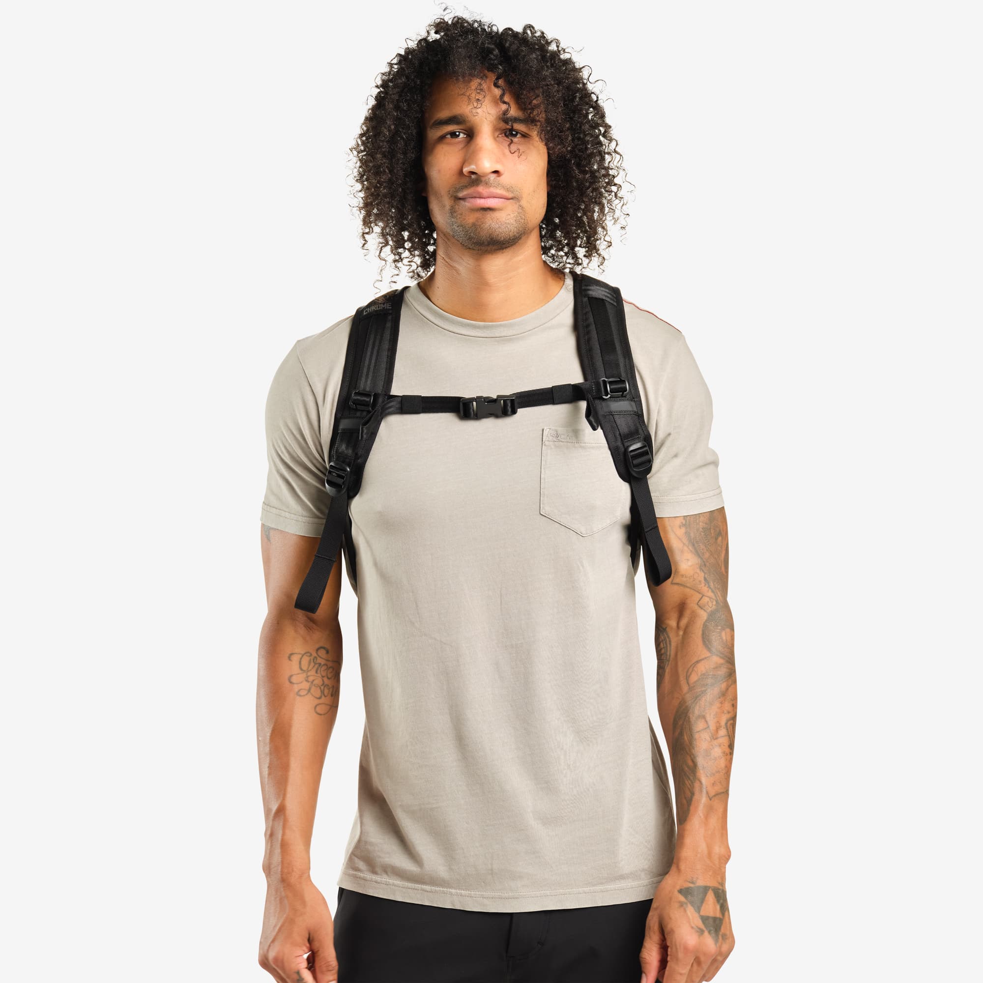 Ruckas 23L Backpack in black worn by a man front view #color_black